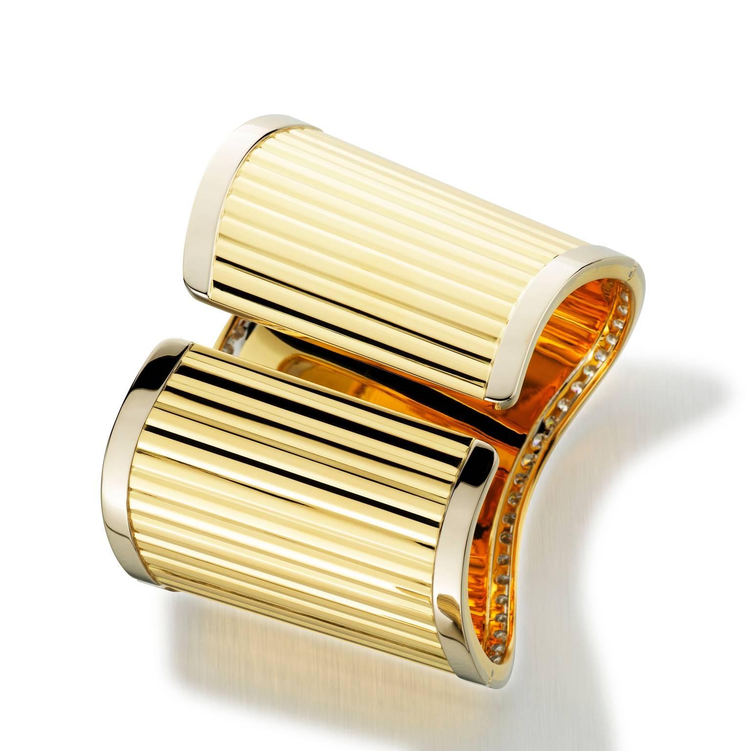 You will be red carpet ready wearing this outstanding Italian hand-fabricated 18k yellow gold cuff bracelet. Bracelet is double spring hinged, featuring a ribbed mirrored finish accented with 7.17 Cttw VS F-G diamonds and a smooth mirrored finish on
