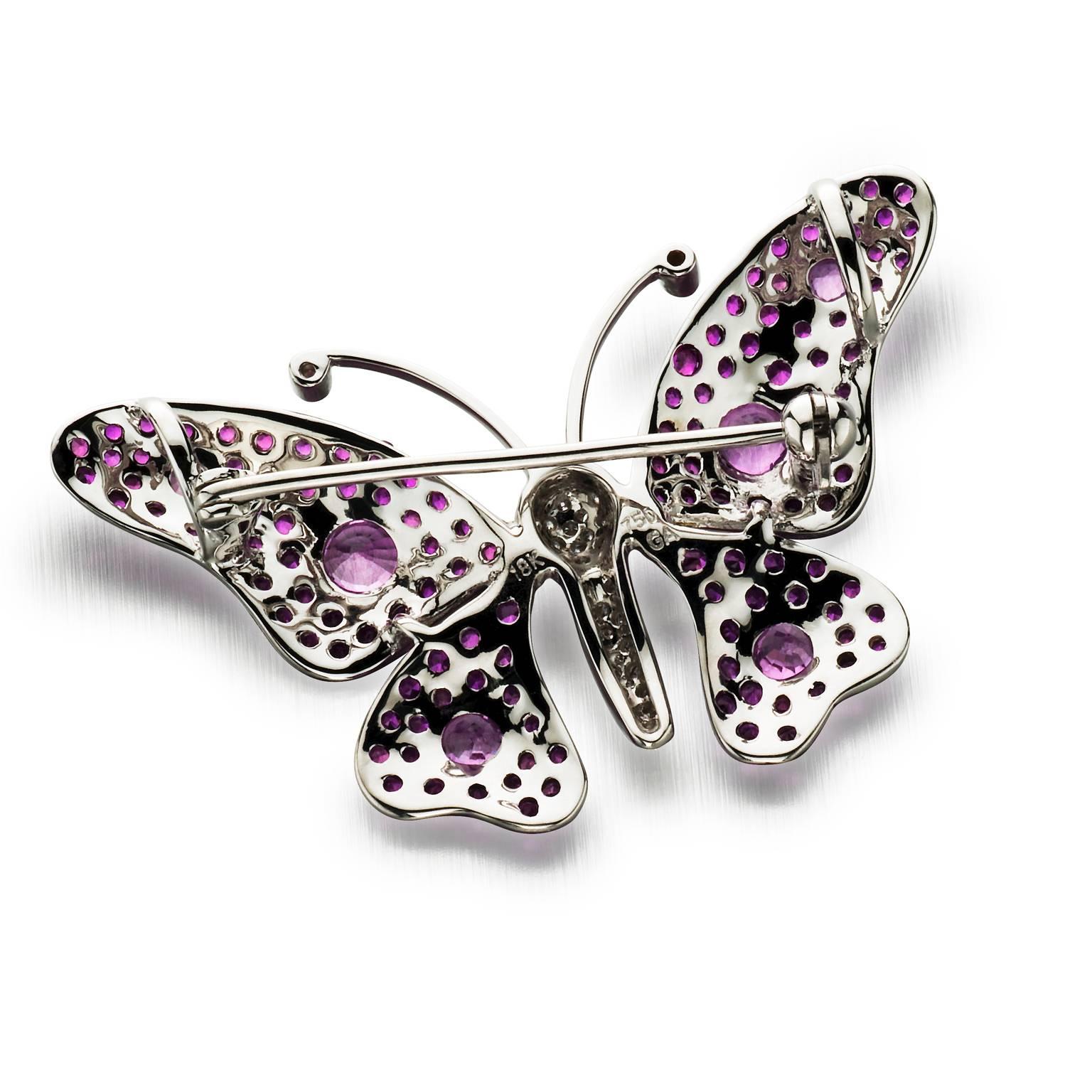 Accent that little black dress with a pop of color. Stylized 18k white gold butterfly brooch featuring hot pink spinels on wings, accented with six round pink sapphires. Body is pave set with round brilliant cut diamonds.

1.30 cttw Pink