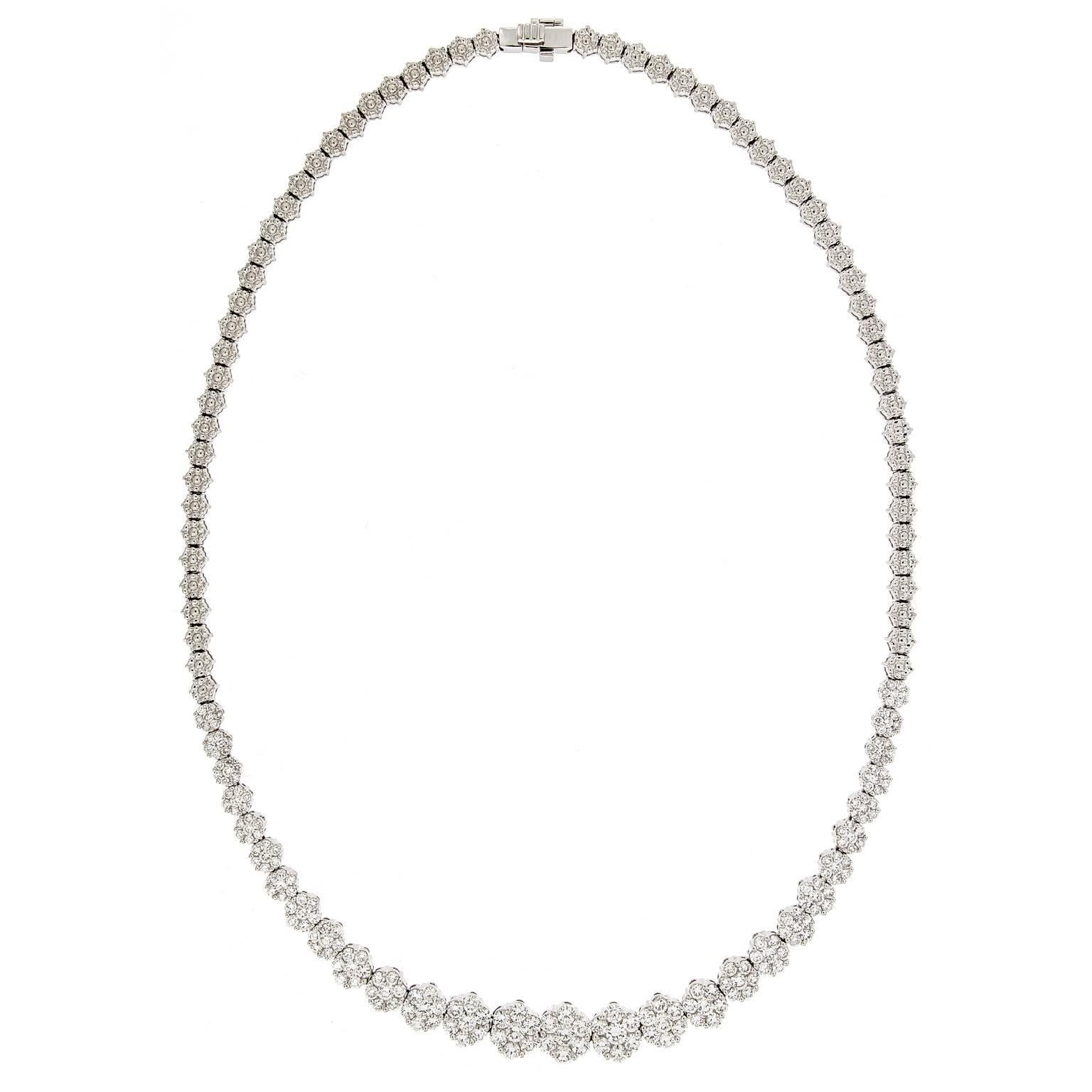 Delicately resting upon her neck, this masterpiece of shimmering diamond flower buds is set in 18k white gold. Necklace features 18k white gold flower bud links that flow into 7.0 cttw of round diamonds.