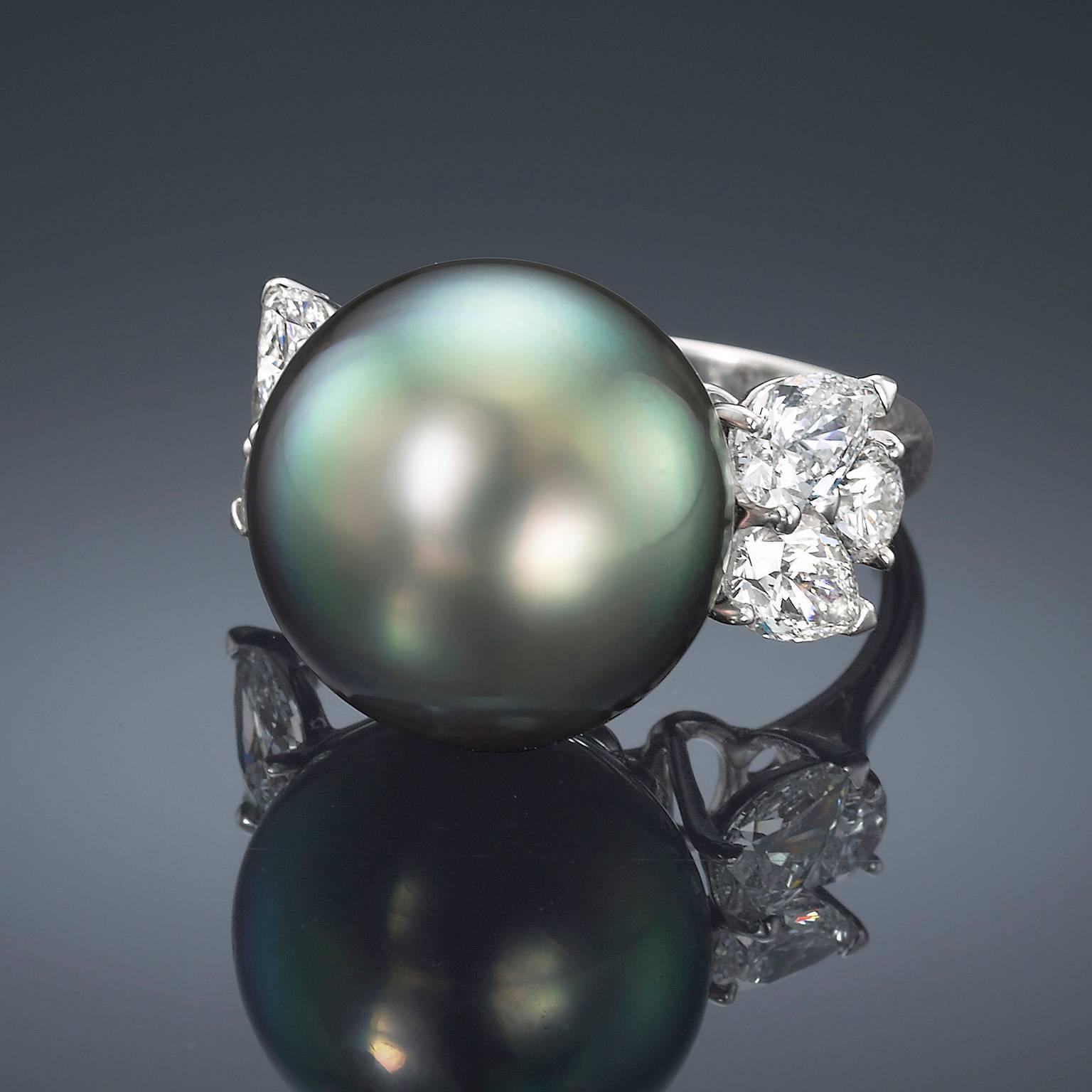 This stunning ring from Assael of New York is hand set in Platinum. Full Cut Pear and Round Diamonds highlight the luster and iridescent orient of this stunning Natural Color Tahitian Cultured Pearl. 
Size: 6
Gem quality Cultured Pearl, 14.8 -