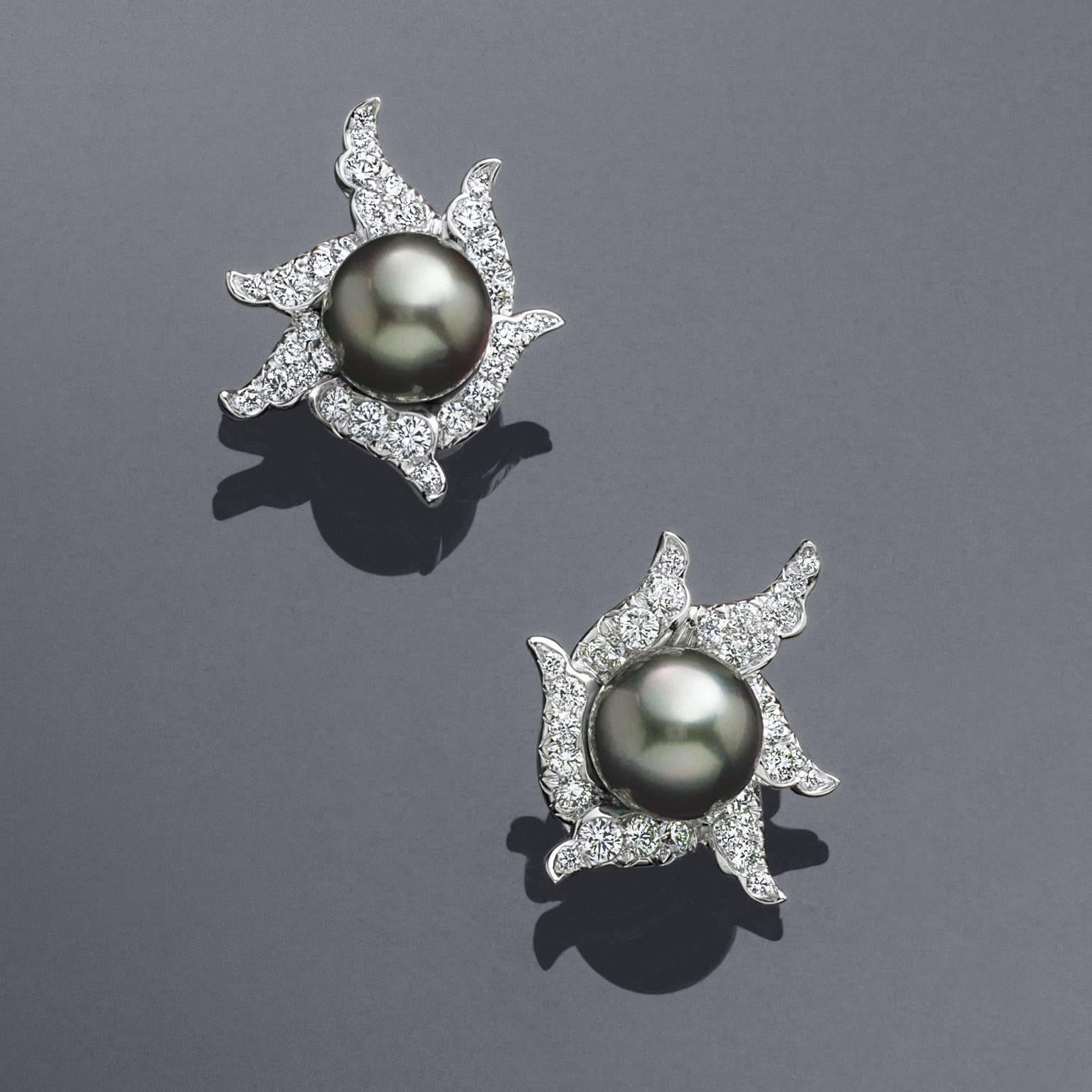 Dark, dramatic Tahitian Cultured Pearls are set in white-capped waves of diamonds in these statement button earrings. Earrings are platinum and 18K white gold. Designed by Angela Cummings for Assael of New York. 

Pair of Gem Quality 11.9 mm