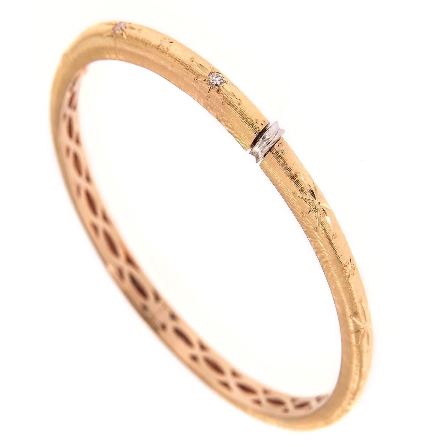 18k rose gold hinged bracelet, accented with round-cut diamonds. Bracelet is inspired by the classic Buccellati design featuring textured gold made to look like fine fabric. 
Inner diameter measures 2.25 in x 2 in

Diamond 0.35 cttw