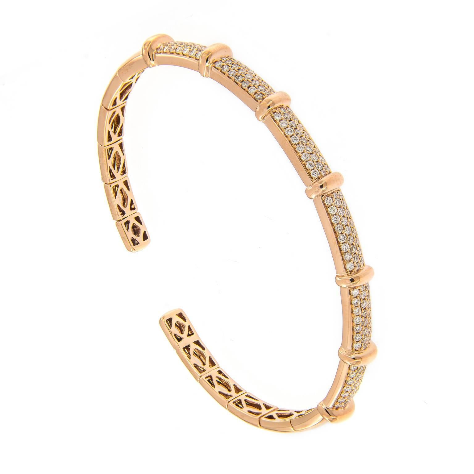 Three rows of round brilliant cut diamonds separated by gold bar stations are beautifully crafted in 18k rose gold. Striking on it’s or stack two or more to create a bolder look. Bracelet is flexible. Inner diameter 2 in w 2.25 in. 6 mm