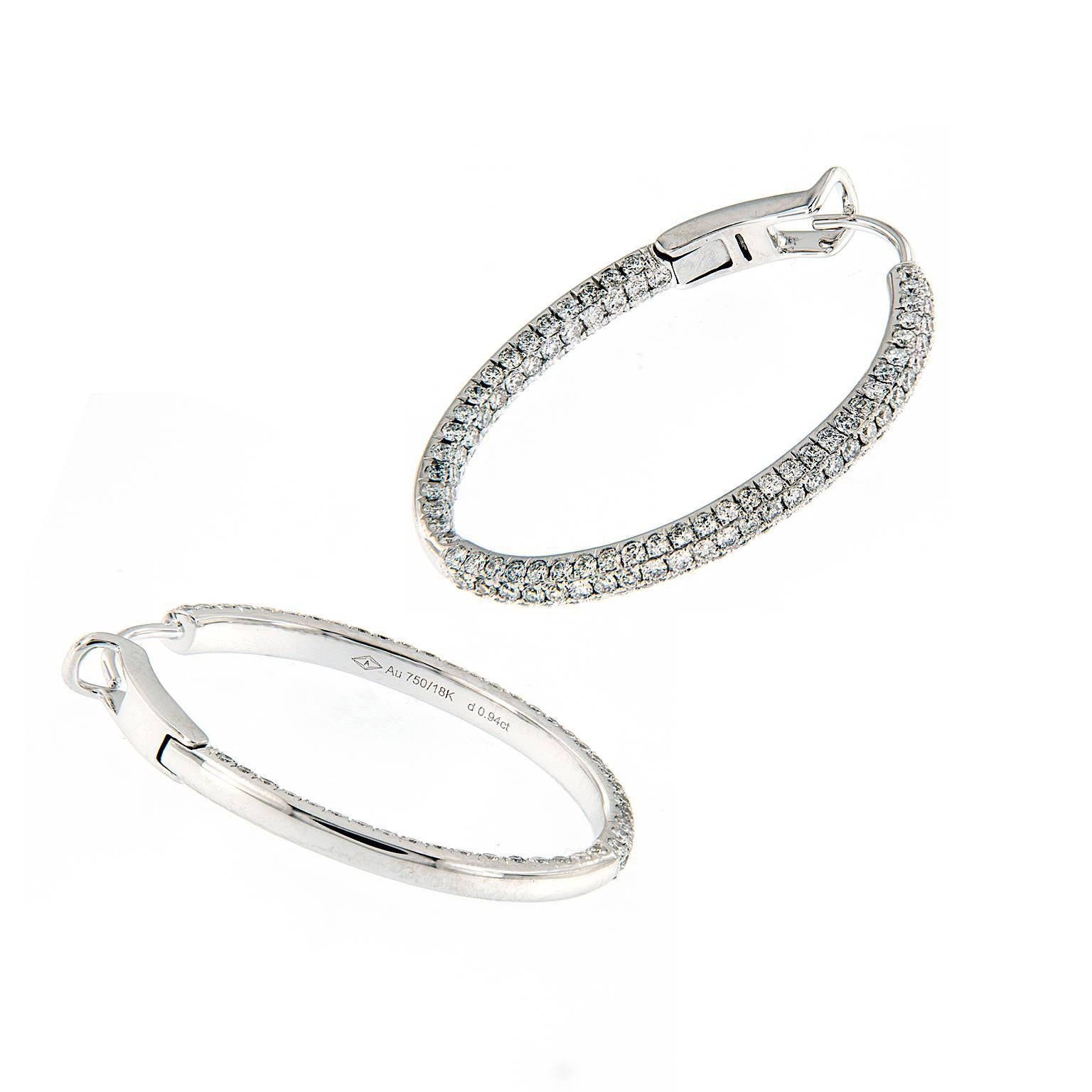 Sparkle and shine from the inside out. These inside-outside oval hoop earrings showcase round brilliant-cut diamonds in 18k white gold. Weigh 6.4 grams. 

Diamonds 1.88 cttw