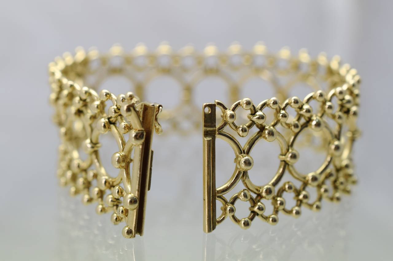 Impressive! Tiffany and Co.  gold bracelet, 
with  3 rows of beaded circles, lacy open work design.

Length of the bracelet is 7 inches
Width is 1 inch
Makers hallmark: Tiffany and Co 750