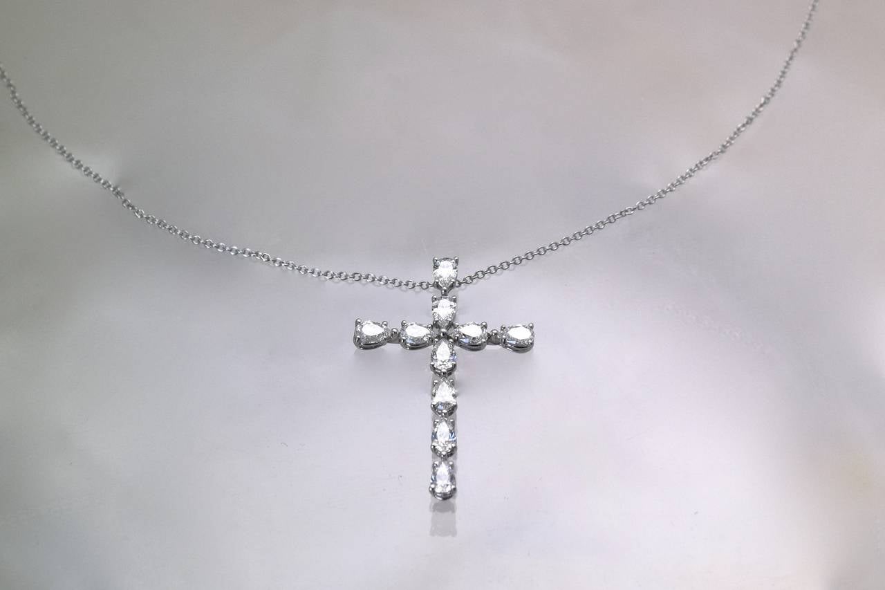 Diamond Cross by Harry Winston !
10 top quality pear shape diamonds set in platinum. 
Diamonds are  D/E Color & VS clarity.
Chain is 16 inches long with hidden clasp.
Maker's hallmark: HW 91505 PT950
Platinum
In its original box and with