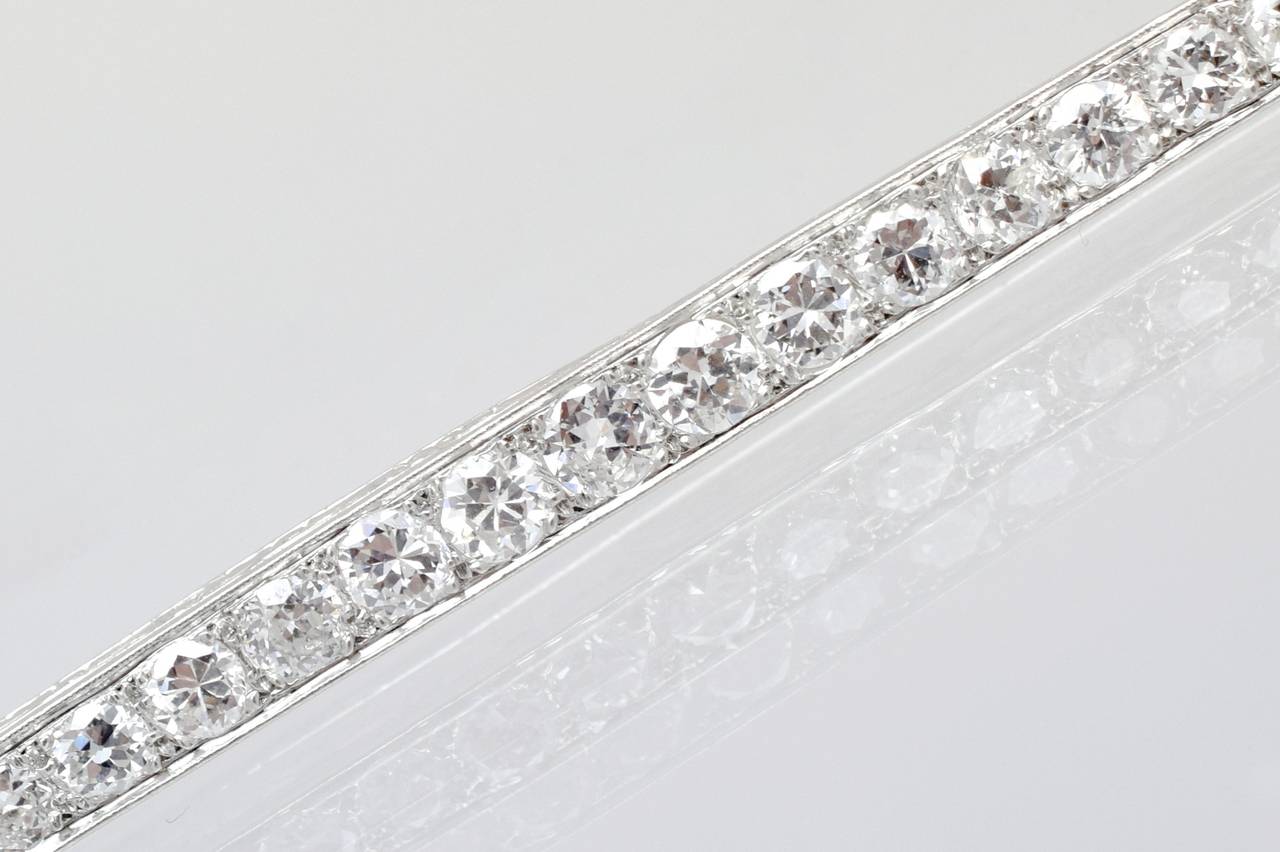 Timeless! Van Cleef and Arpels diamond bar pin.

With 31 gradual Old European fine quality brilliant shape diamonds set in platinum, with estimated total weight of the diamonds 4 carats. Both sides have beautiful foliage engraving with the maker's