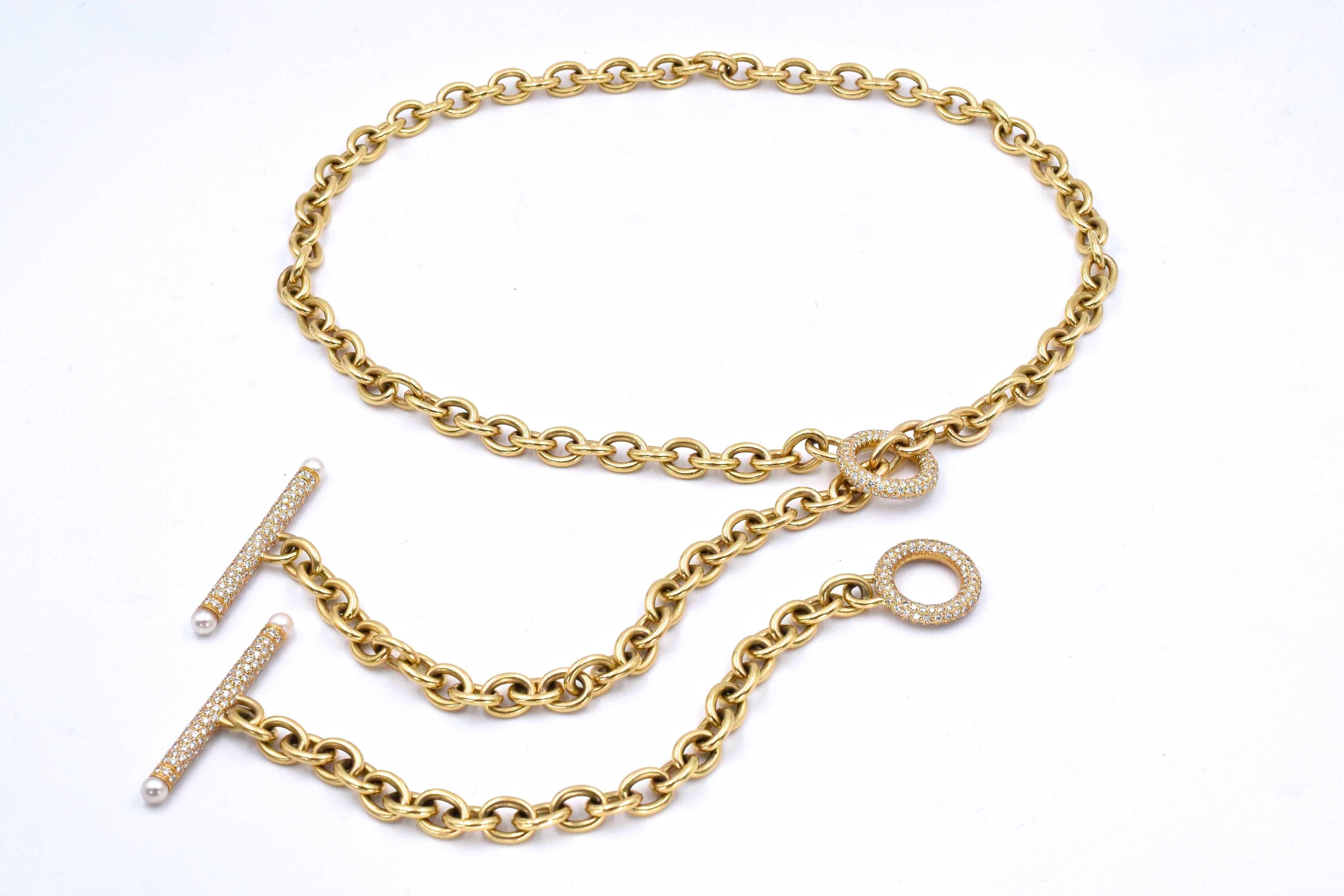 A Yellow Gold, Diamond and Cultured Pearl Long chain by Oscar Heyman Brothers. 
This necklace  consisting of 14 karat yellow gold oval link cable link chain with an 18 karat yellow toggle gold clasp containing numerous round brilliant cut diamonds