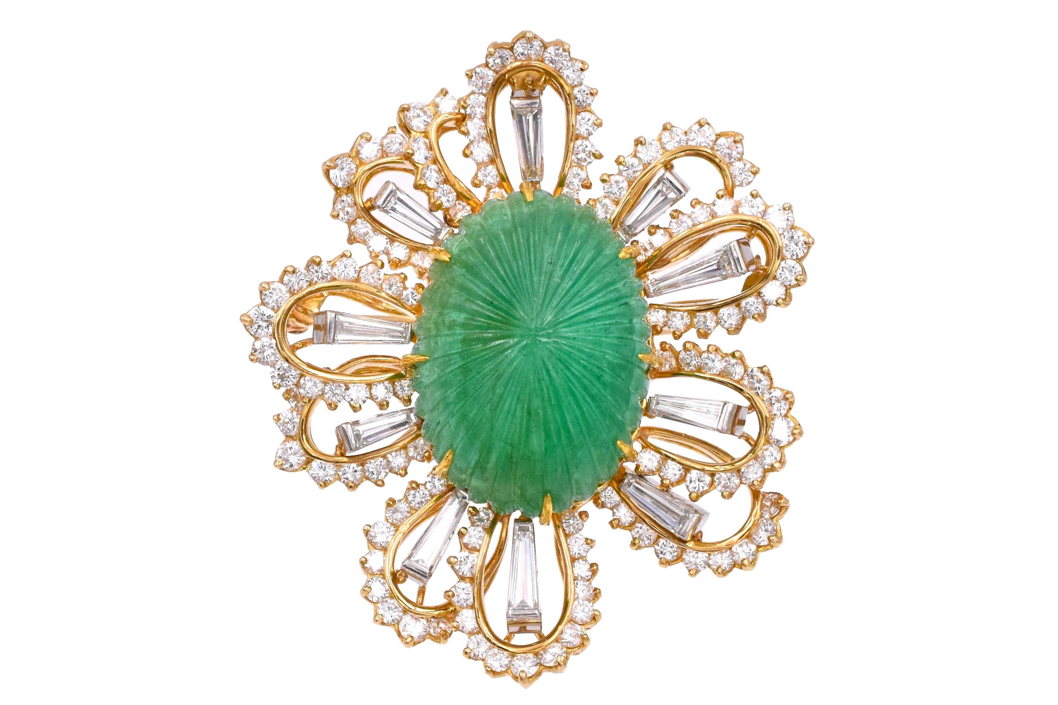  Oscar Heyman, Circa 1971,  Emerald and Diamond Brooch
consisting of a central oval carved emerald weighing approximately 36.22 carats within stylized foliate setting containing brilliant  diamonds weighing approximately 4.70 carats total and 
