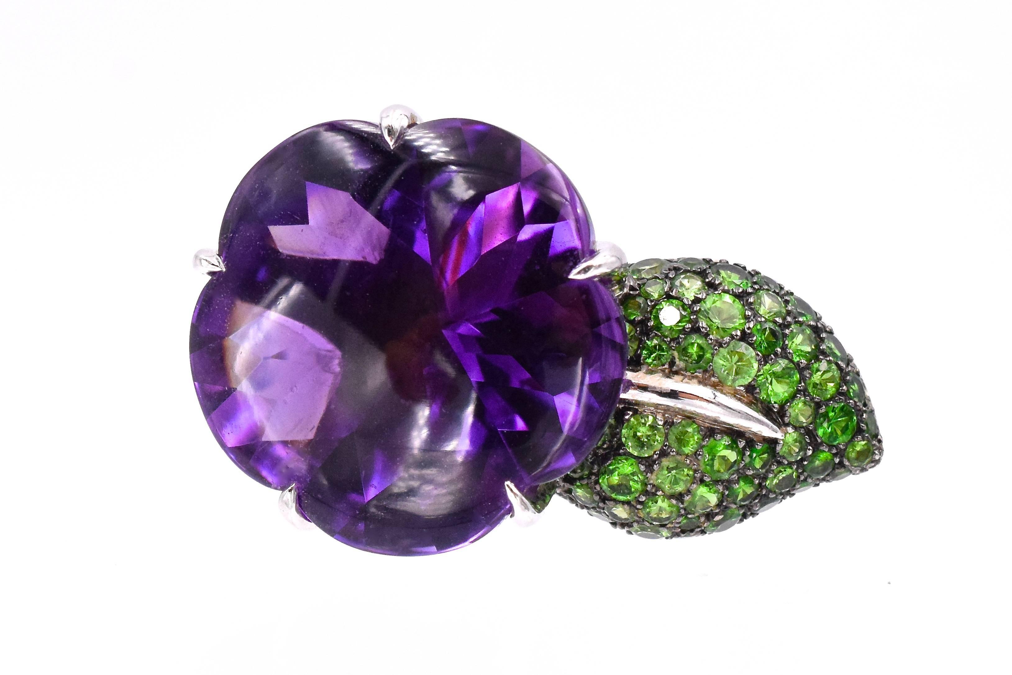  Amethyst and Tsavorite Ring by  Chanel, 
in a stylized foliate motif, containing one fancy mixed cut flower motif amethyst measuring approximately 21.90 mm in diameter, together with numerous round mixed cut tsavorite pave set in a leaf design