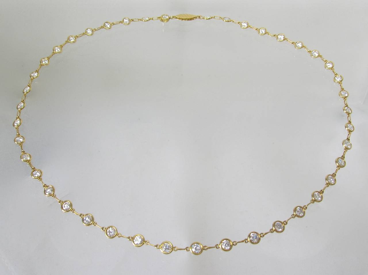 Classic, Elisa Peretti diamonds by yard necklace , with 42 brilliant diamonds set in 18k gold bezel style. Each diamond is 0.15 carats with the total diamond weight of 6.30 carats.
Color of the diamonds is E/F, clarity VS
Length of the necklace is