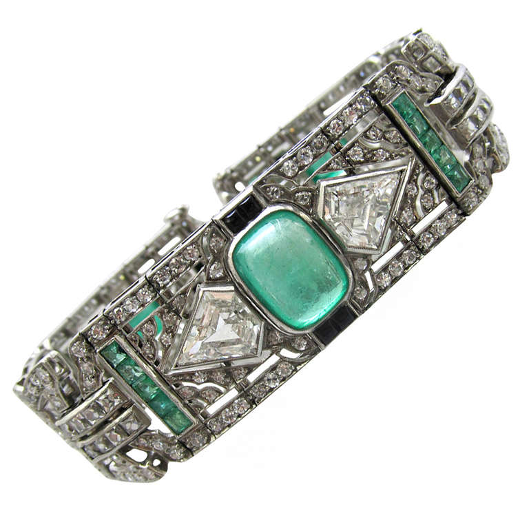 Beautiful Art Deco Bracelet !
Diamond, cabochon emeralds and onyx set in platinum.
2 center kite shape diamonds are 2 carats each

Measurements:
Length: 8 inches
Width: .75 inches