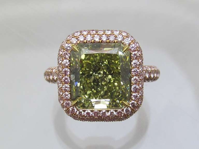 One of a Kind Color Diamond Ring!
Unique Intense Green color diamond surrounded with 174 natural pink color diamonds.
Center diamond details are:
Size:      7.08 carat
Shape:  Cornered Rectangular Modified Brilliant
Color:    Fancy Intense