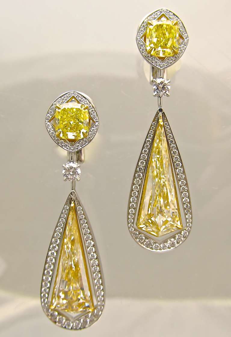 Magnificent! Kite shape Diamond Ear Pendants!
Two top cushion shape diamonds.
1.29 carat 
G.I.A. Certified Fancy Vivid Yellow & VVS2 Clarity
1.27 carat
 G.I.A. Certified: Fancy Vivid Yellow & SI1 clarity
Two pair of kite  shape diamonds with