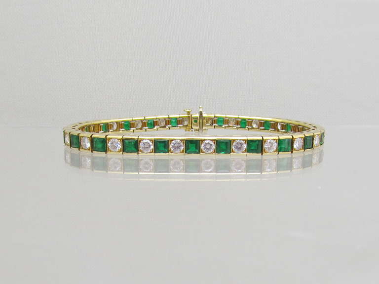 Timeless diamond  and emerald bracelet in 18k gold, channel style set alternating 24 brilliant diamonds and 24 asscher cut emeralds.

Estimated total diamond weight is: 3.60carats
Estimated total emerald  weight is: 2.70 carats
18k gold.

Signed:  