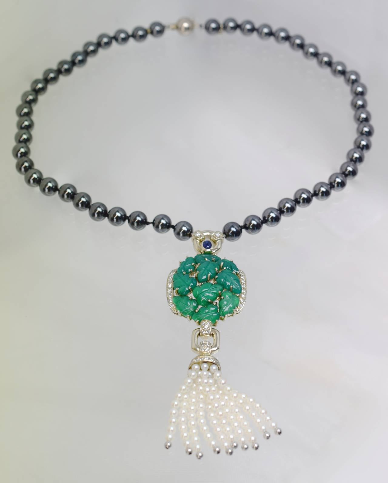 Cartier! chalcedony, & hematite  sautoir.
The necklace is comprised of  hematite beads as the chain & tasle that has 10 carved chalcedony leaves with diamond borders & 10 strands of pearls.
Necklace  is 15