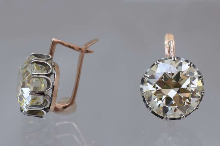 Stunning Old European cut brilliant diamond earrings.

11.30 carat & 11.20 carat old European brilliants set in double claw style.
Oxidized silver and 14k rose gold wire lever back closures
Makes a great statement!
Diamonds are  off color  (