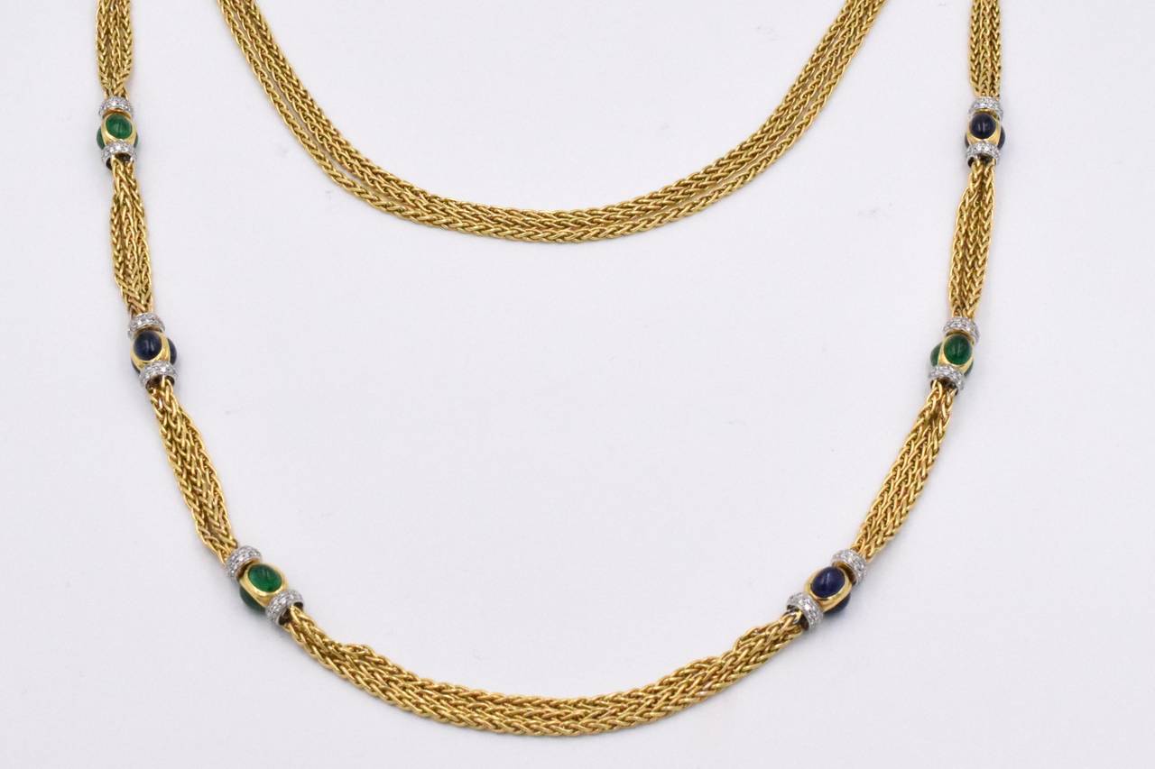 Three strand of 18k gold fancy woven design link necklace with 8 intervals of cabochon sapphires & emeralds set in gold bezels & caped by diamond rondelles.
 Estimated total diamond weight is 5.70 carats
Gold weight is 145 grams ( 93dwt)
18 k gold