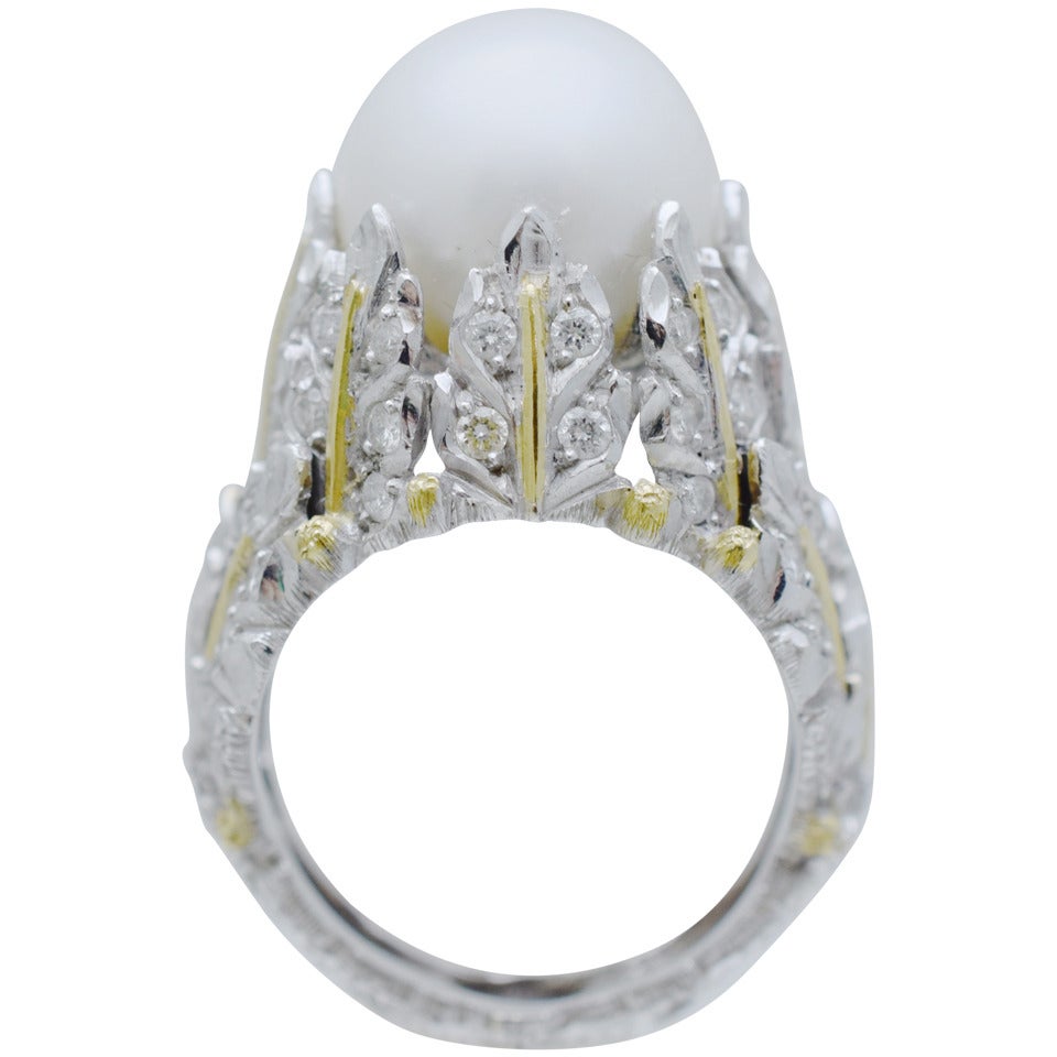 Very impressive M. Buccellati ring designed as stylized textured white/yellow gold maple leaves encrusted with 64 brilliant shape diamonds holding 12MM  pearl.
Signed: M Buccellaty Italy 750.
Ring size: 6.5