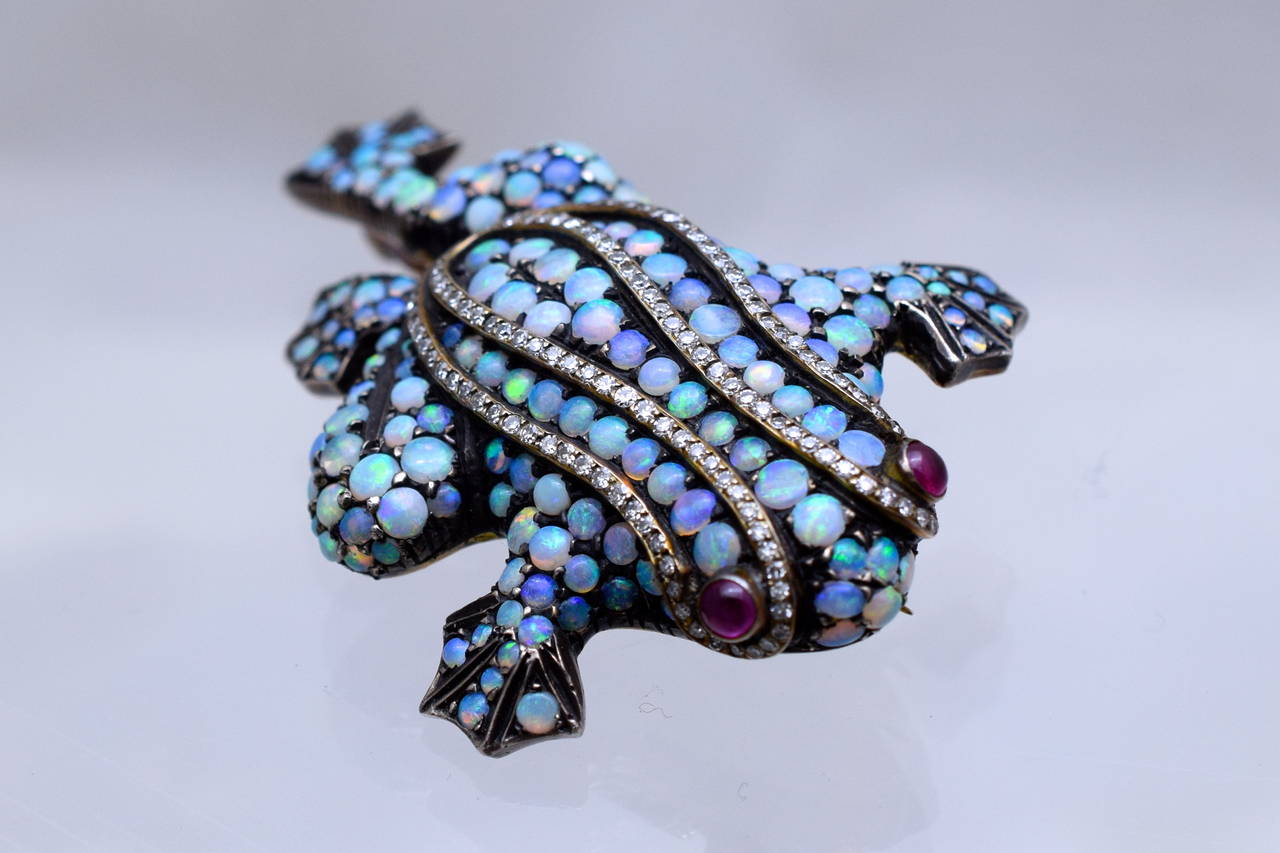 Adorable colorful frog brooch!
Covered with 165 colorful cabochon opals & a double raw of 132  diamonds.
 Eyes are cabochon  ruby.
Estimated diamond weight is 1 carat
Gold & Silver