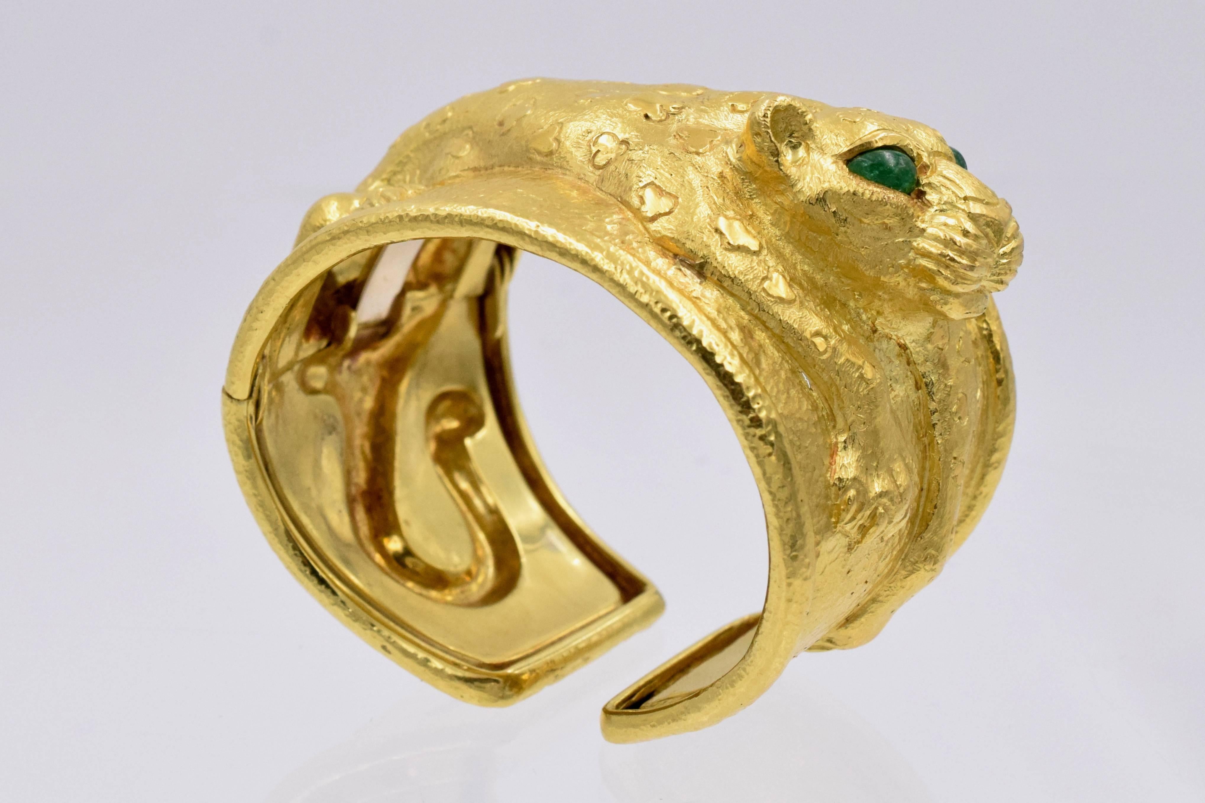 Bold look of David Webb gold cuff bracelet,  18k yellow gold with emerald eye leopard on the top .
Maker's signature: David Webb
Weight: 99 grams
Wrist size is: 6 inches