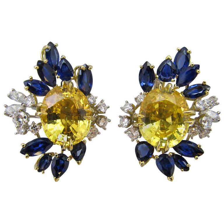 Yellow and blue sapphire with accented diamonds earrings by Meister

Two center oval shape yellow sapphires are  20.65 carats ,18 pear shape marque shape sapphires are 5 carats and 1.50 carats of marque diamonds.
Signed MEISTER Swiss

