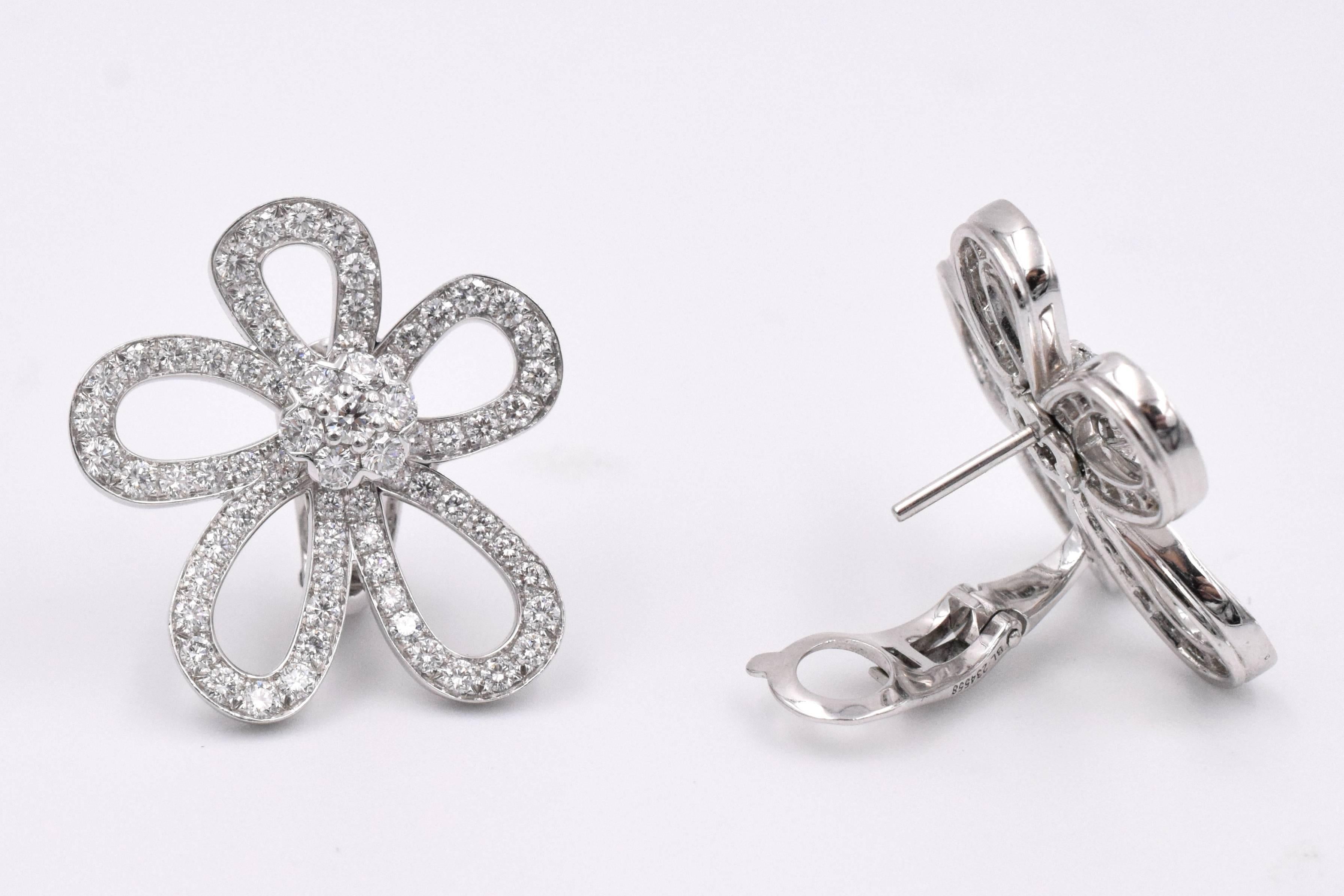 V.C.A. Flowerlace Earrings in 18k White Gold.
Centered around a sparking fleurette motif, the elegant curved diamond petals give a light airy look to these delicately extravagant ear-clips. 
142 Brilliant Cut Diamonds with a total weight around
