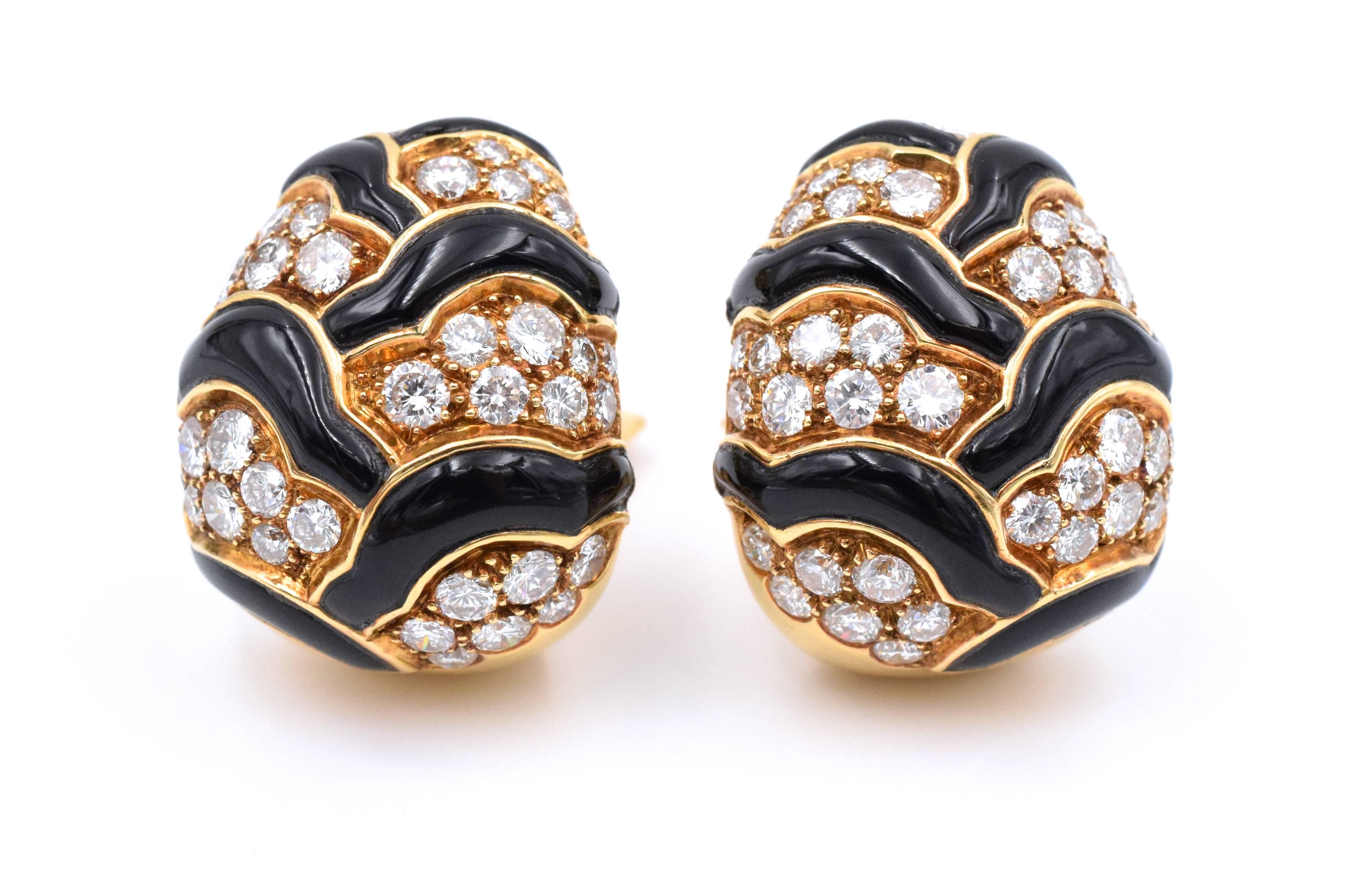 Onyx And Diamond Ear-clips By Van Cleef and Arpels. Set In 18 Karat Yellow Gold, Consisting Of Several Pave Set Sections Divided By Inset Carved Onyx Sections.

Ear-clips Contain 68 Round Brilliant Cut Diamonds Weighing Approximately 5.5 Carats.