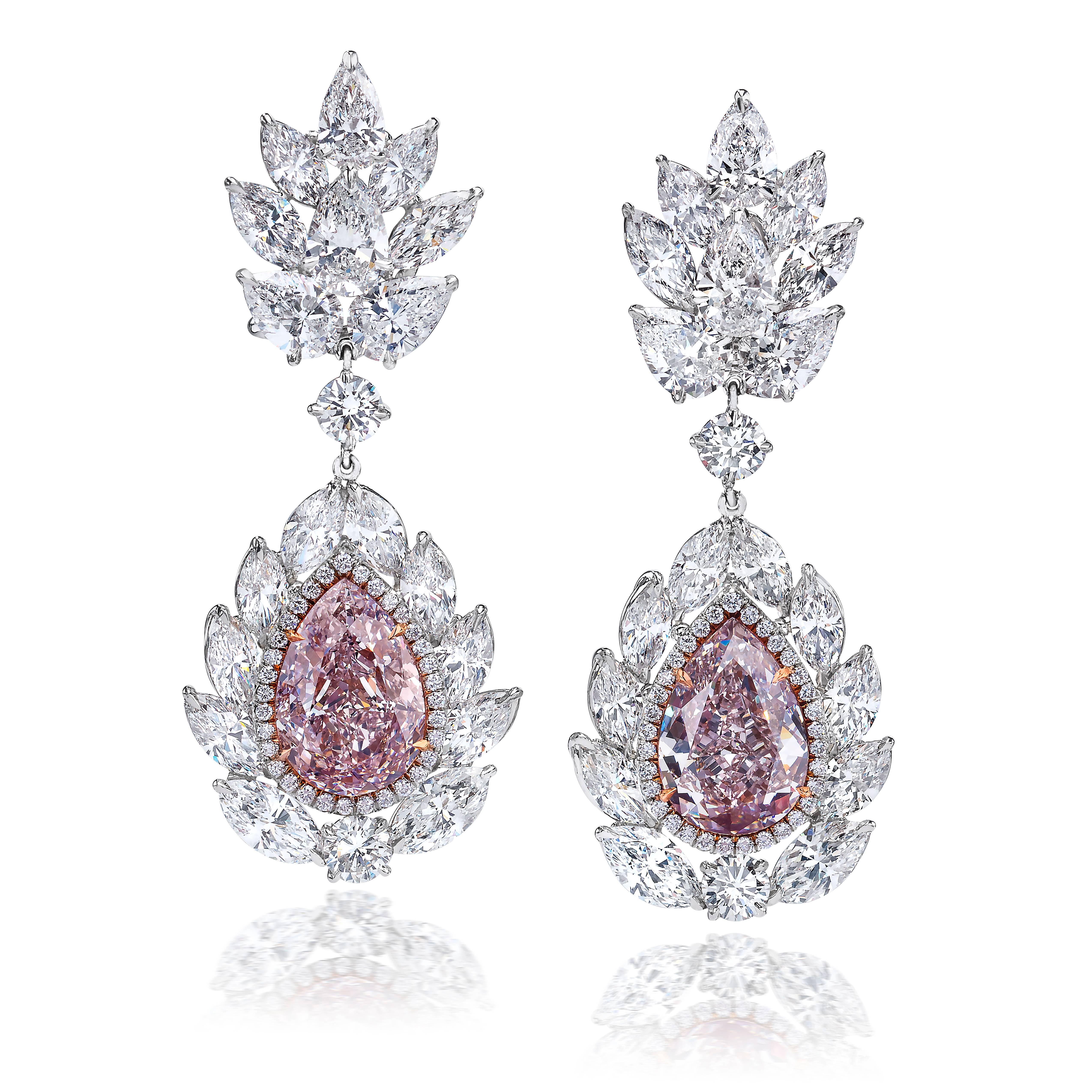 Unique pink diamond earrings!!!!!

Two pear-shaped pink diamonds surrounded by 28 marquise, 8 pear & 4 brilliant shape diamonds with the total weight of 11.75 carats set in platinum.

Pink diamond info:
3.59 carat pear shape natural light pink
