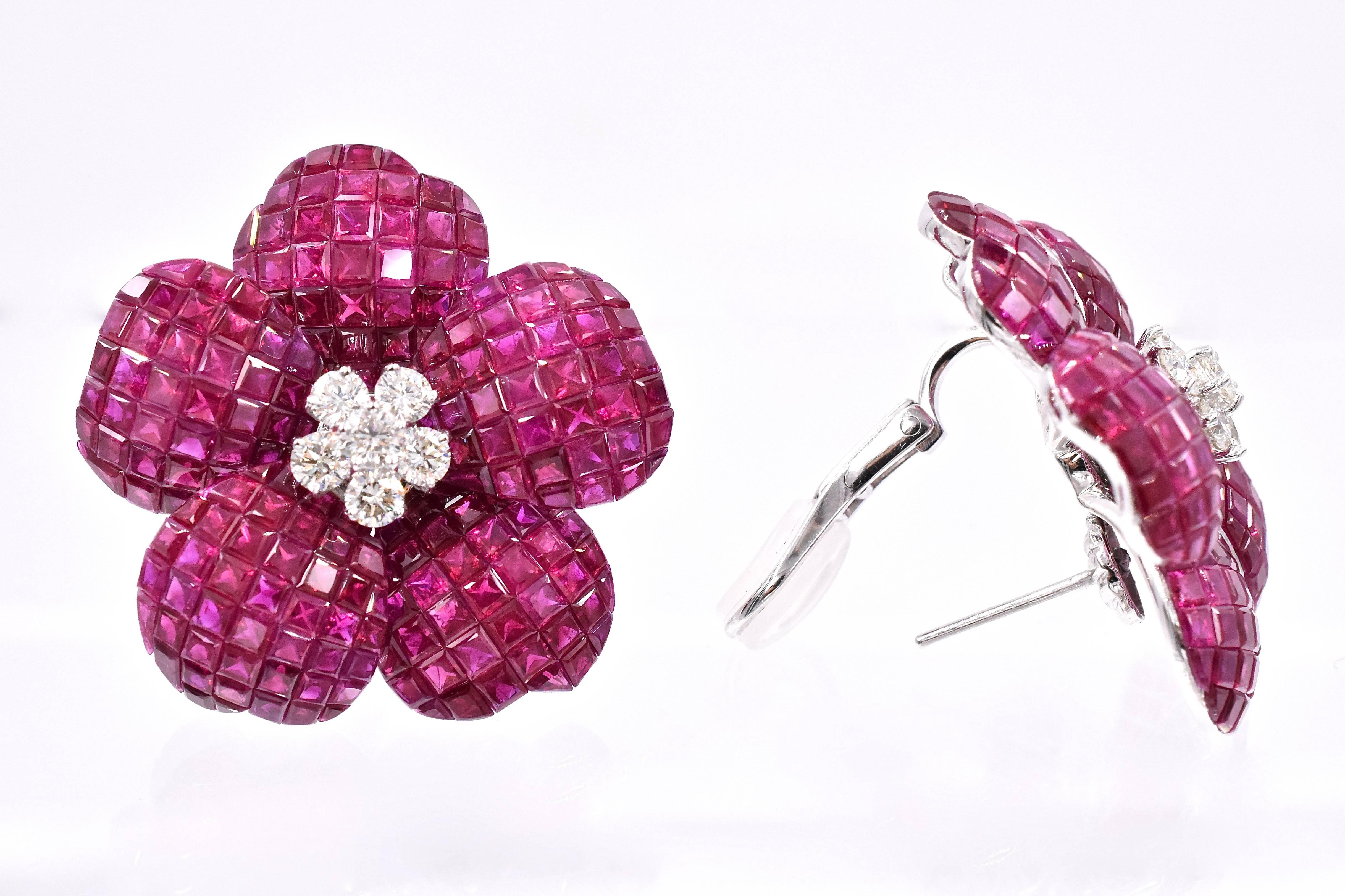 Classic  ruby and diamond flower earrings. 
Five mystery set ruby flower petals centered with 5 diamonds.
Estimated total ruby weight is 46.88 carats and total diamond weight is 1.5 carats
18 K gold with with omega lock.

