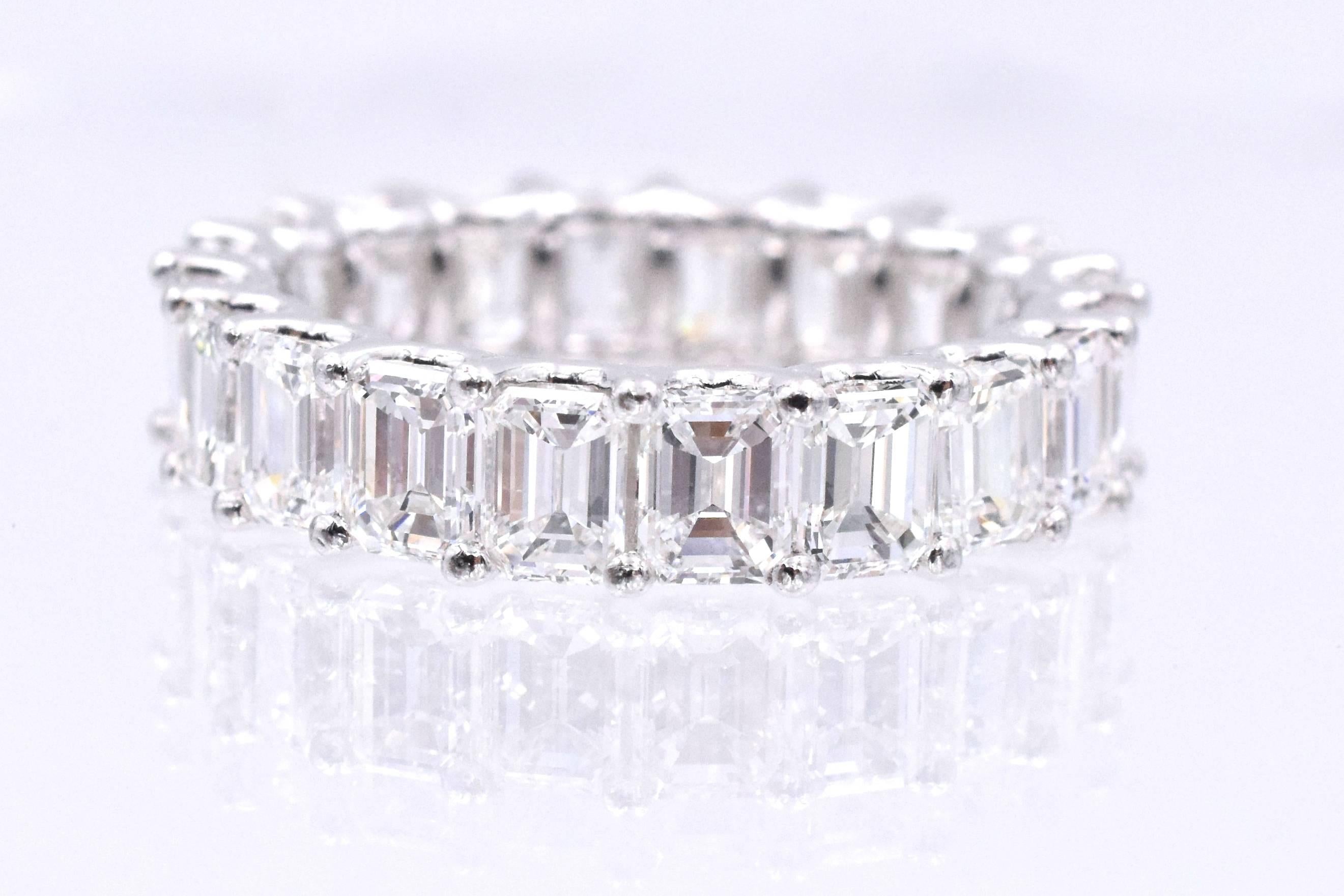 Elegant eternity band with  20 emerald shape diamonds set in platinum with common prong style and U shape shape gellery. Total weight of the diamonds is 5.40 carats and each diamond is 0.27 carat. The diamonds are F color,VS clarity
Ring size: