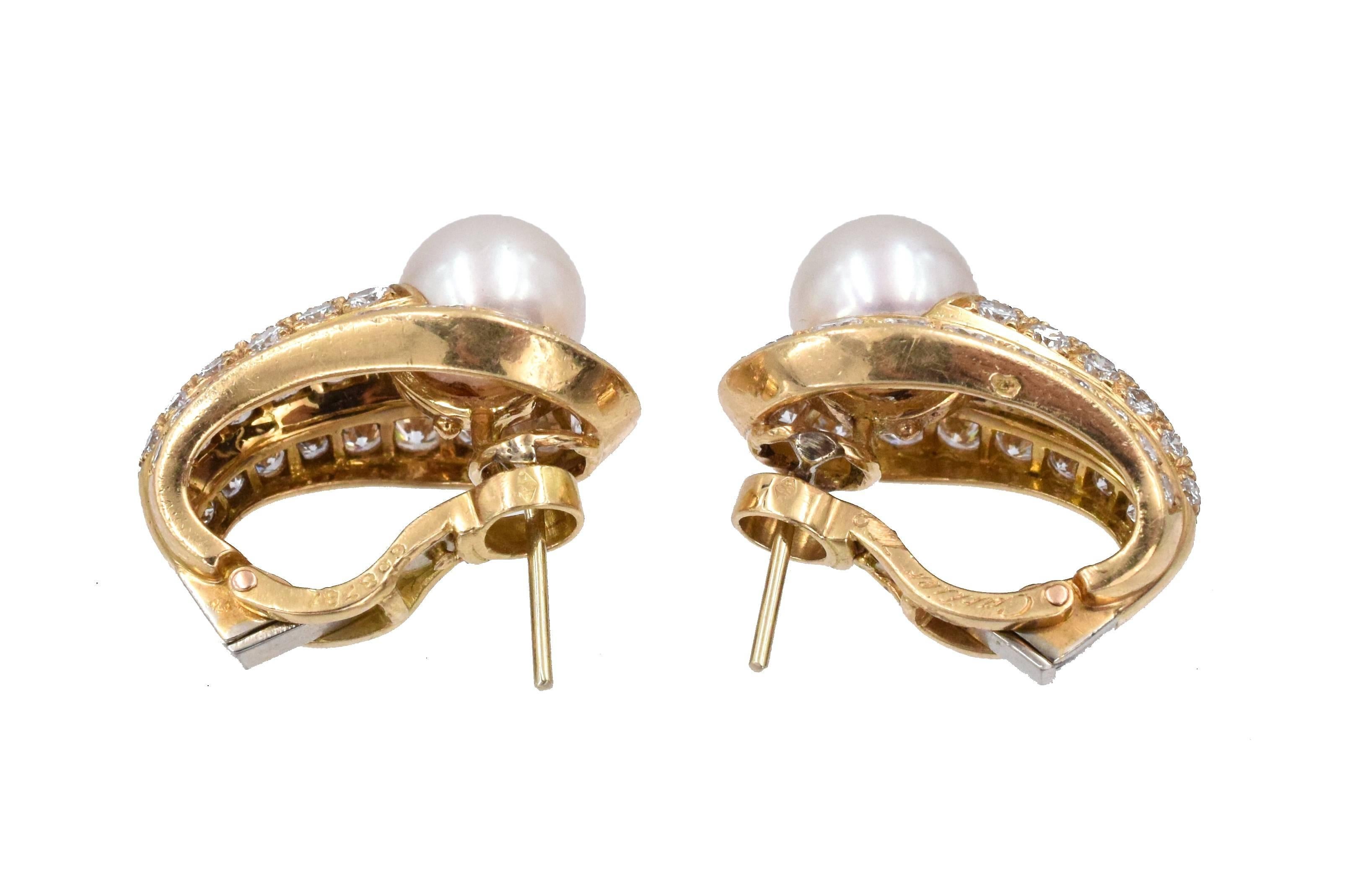 Cartier, France.
Pair of Gold, Cultured Pearl and Diamond Earrings, 
The rounded tapered panels centering 2 pearls approximately 8.0 mm., set with 74 round diamonds approximately 3.45ct.
Measure 7/8 x 9/16 inch. Have posts & clip-backs.
 Signed