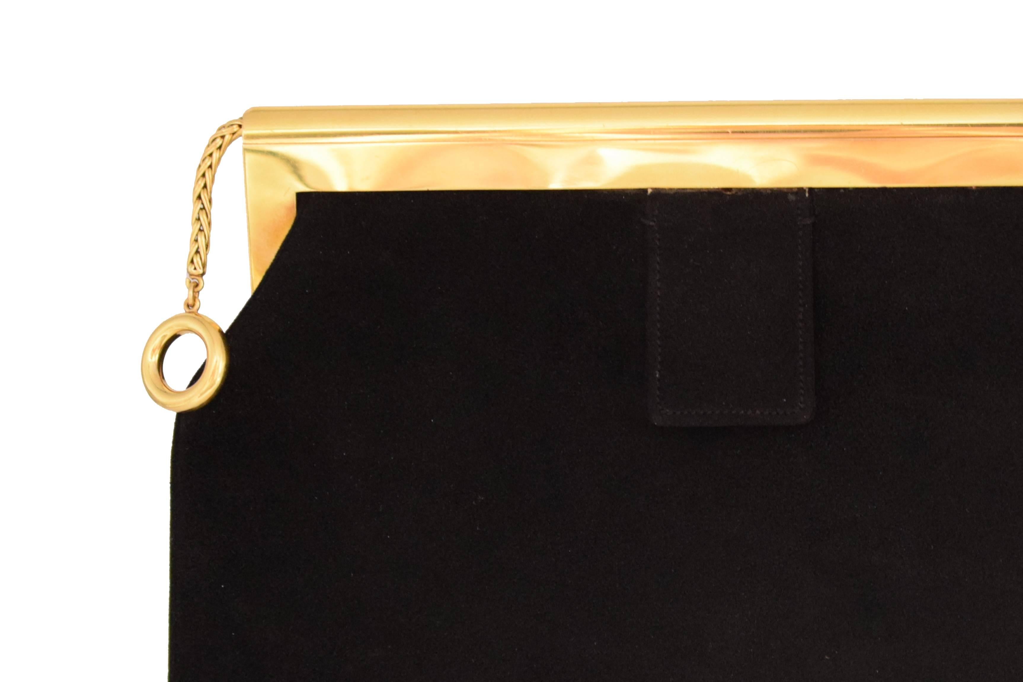 The black velvet bag of trapezoidal shape with a gold frame, numbered, French assay marks, French maker's marks for Cartier. The bag is stamped Cartier, and the gold is stamped with maker's marks for Cartier. Numbered 84771, French maker's marks for