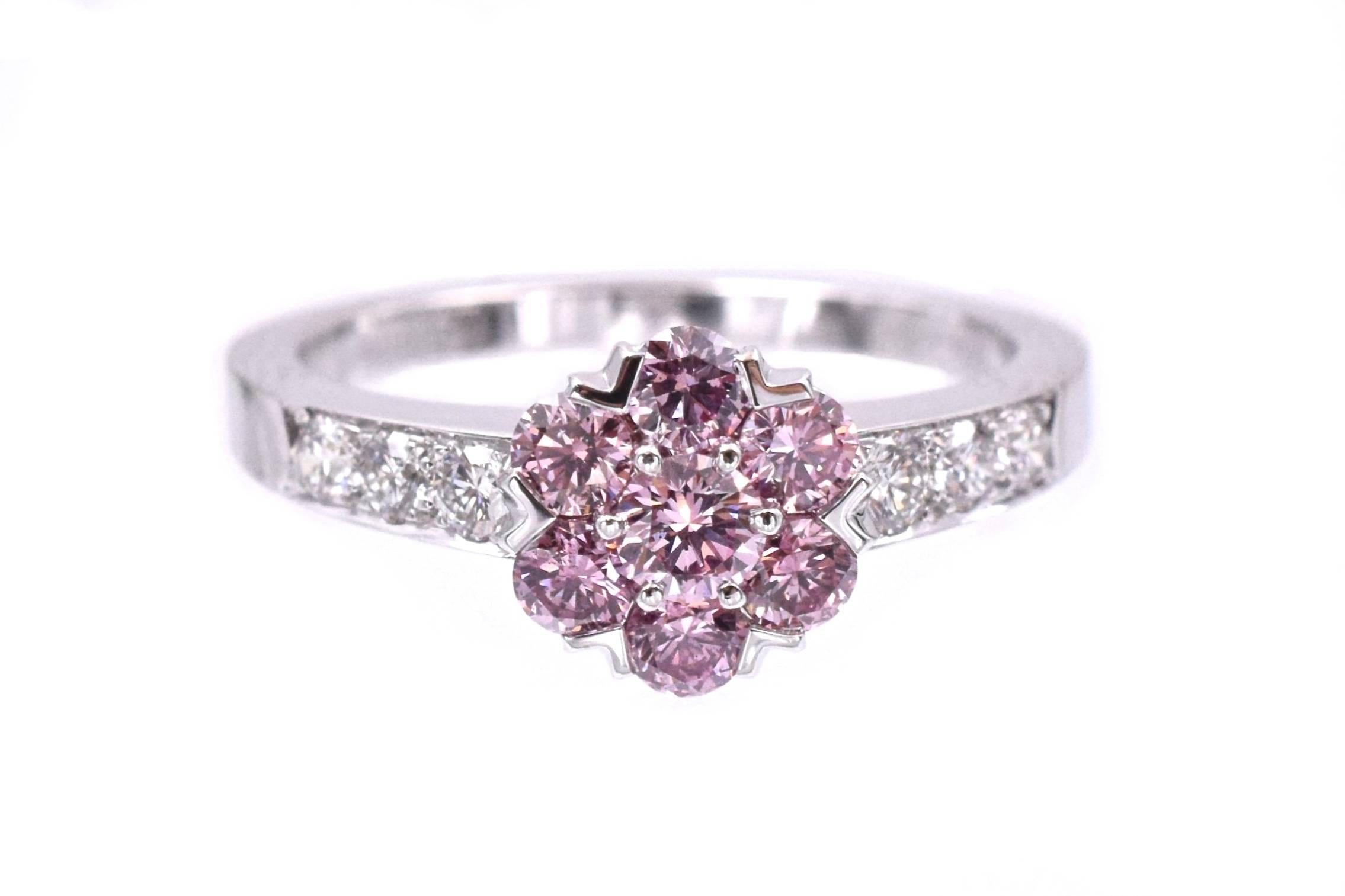 Van Cleef and Arpels Fancy Intense Pink Diamond “Fleurette” Ring
This ring has one Fancy Intense Pink brilliant-cut diamond, weighing 0.14 carats, six Fancy Intense Pink brilliant-cut diamonds, weighing 0.42 carats total, flanked by six round-cut