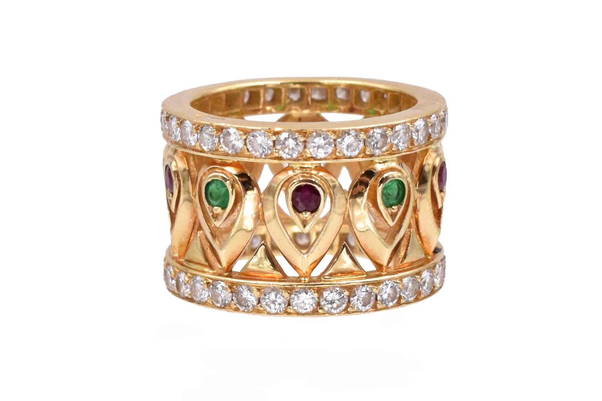 Cartier Diamond and Gemstone  Band
A ring of openwork broad band design, set with circular-cut diamonds, rubies and emeralds; all mounted in 18 karat yellow gold. Signed Cartier, 677586 with French assay and maker's marks.
 Ring size: is US 5¼.