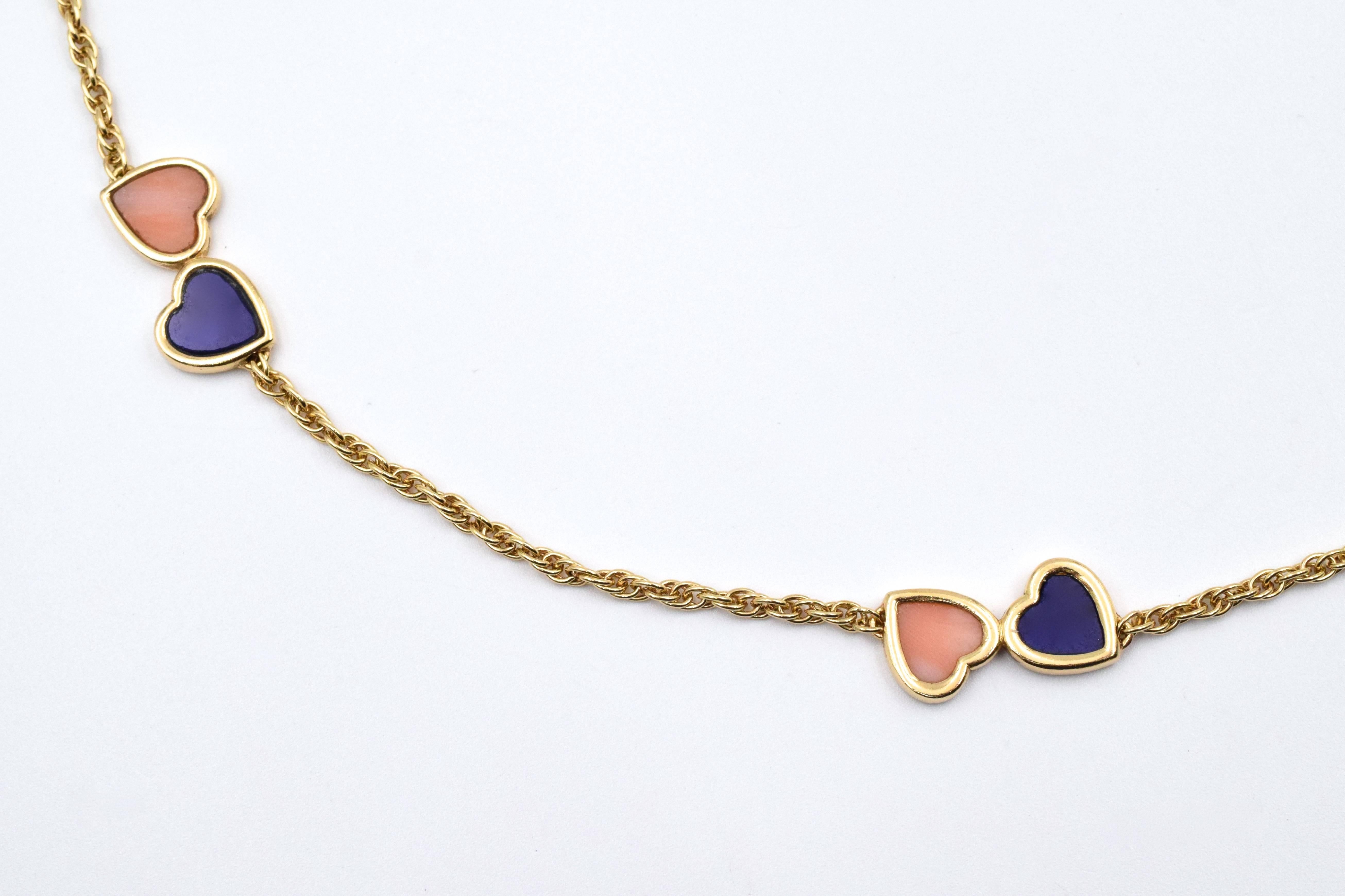 Van Cleef and Arpels Double Heart Lapis Lazuli and Pink Coral Long Chain. This necklace has 10 pairs of hearts along the chain made up of lapis lazuli and pink coral all set in 18k yellow gold.
 Signed Van Cleef and Arpels, # CXXXXXX, and 18k. The