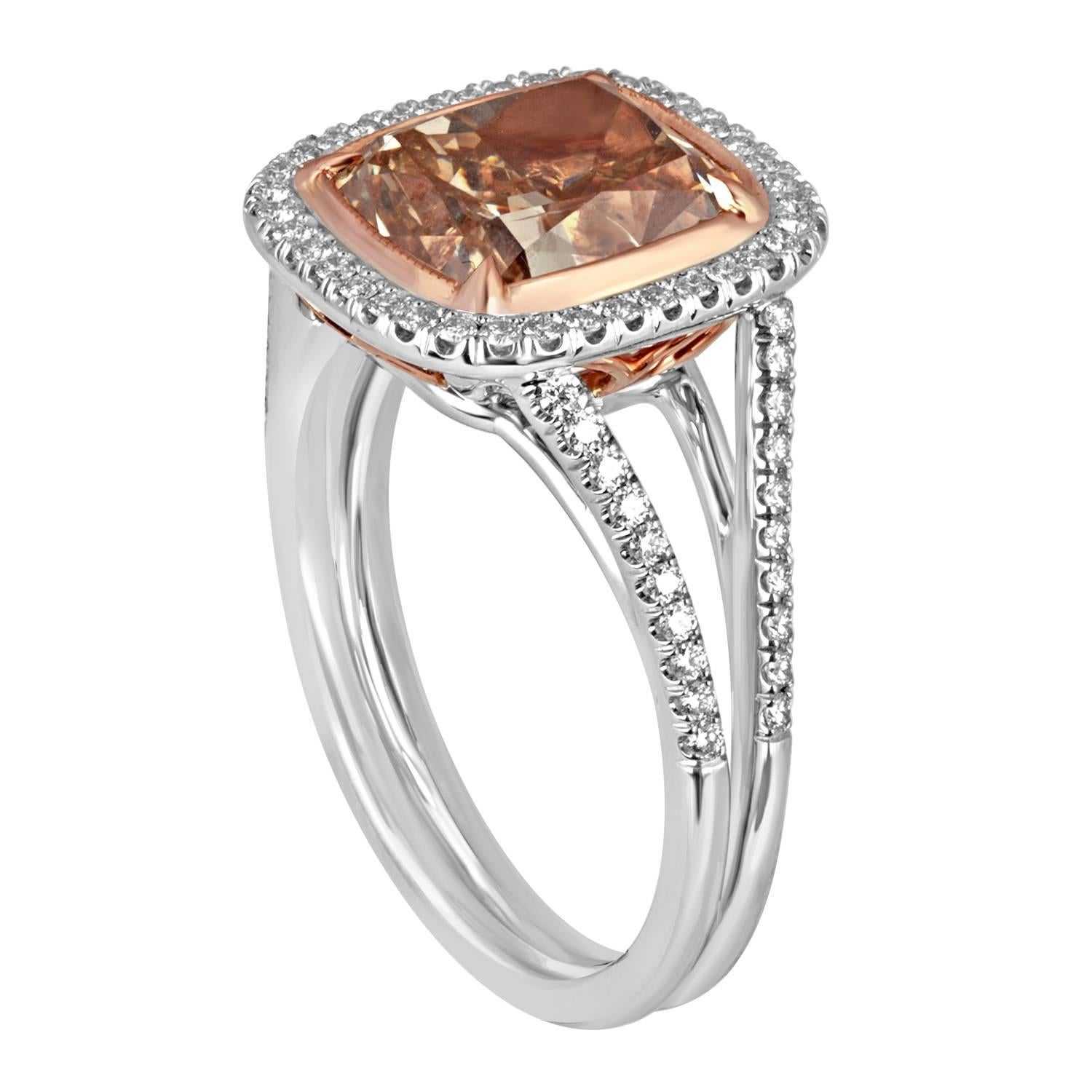 A Beautiful 4.01 Carat Cushion Cut Diamond, EGL Certified as Fancy Deep Brown Orange in Color and SI2 in Clarity is set in Platinum and Rose Gold Mounting. 0.30 Carat Total Weight Round Brilliant White Diamonds are set around the center in Two Rows