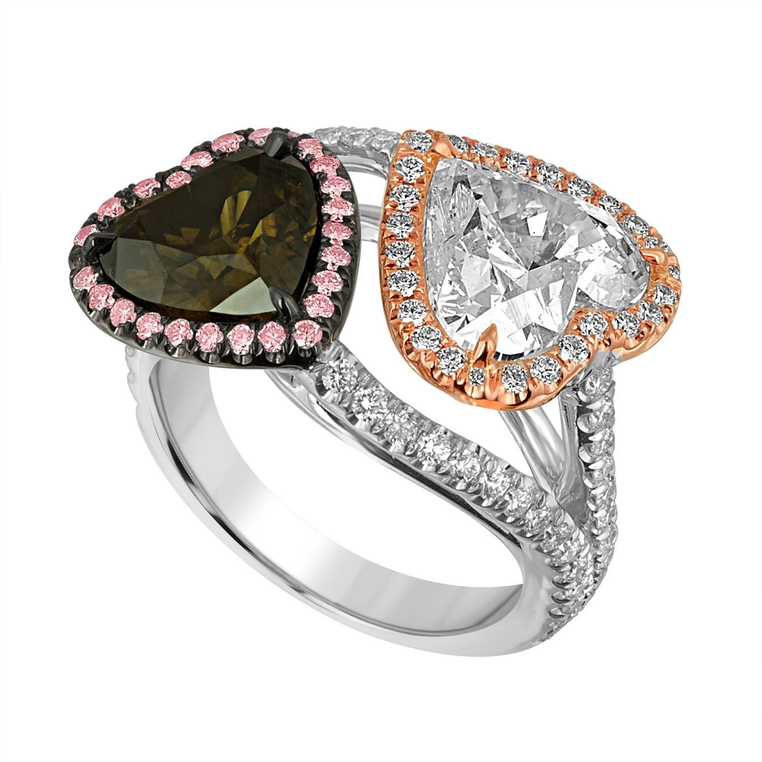 Two Hearts hugging each other. A  3.03 Carat Heart Shape EGL Certified as H in Color and SI1 in Clarity Plus 2.08 Carat Heart Shape GIA Certified Fancy Dark Greenish Brown Diamond are complimenting each other in the way they are set.
The White