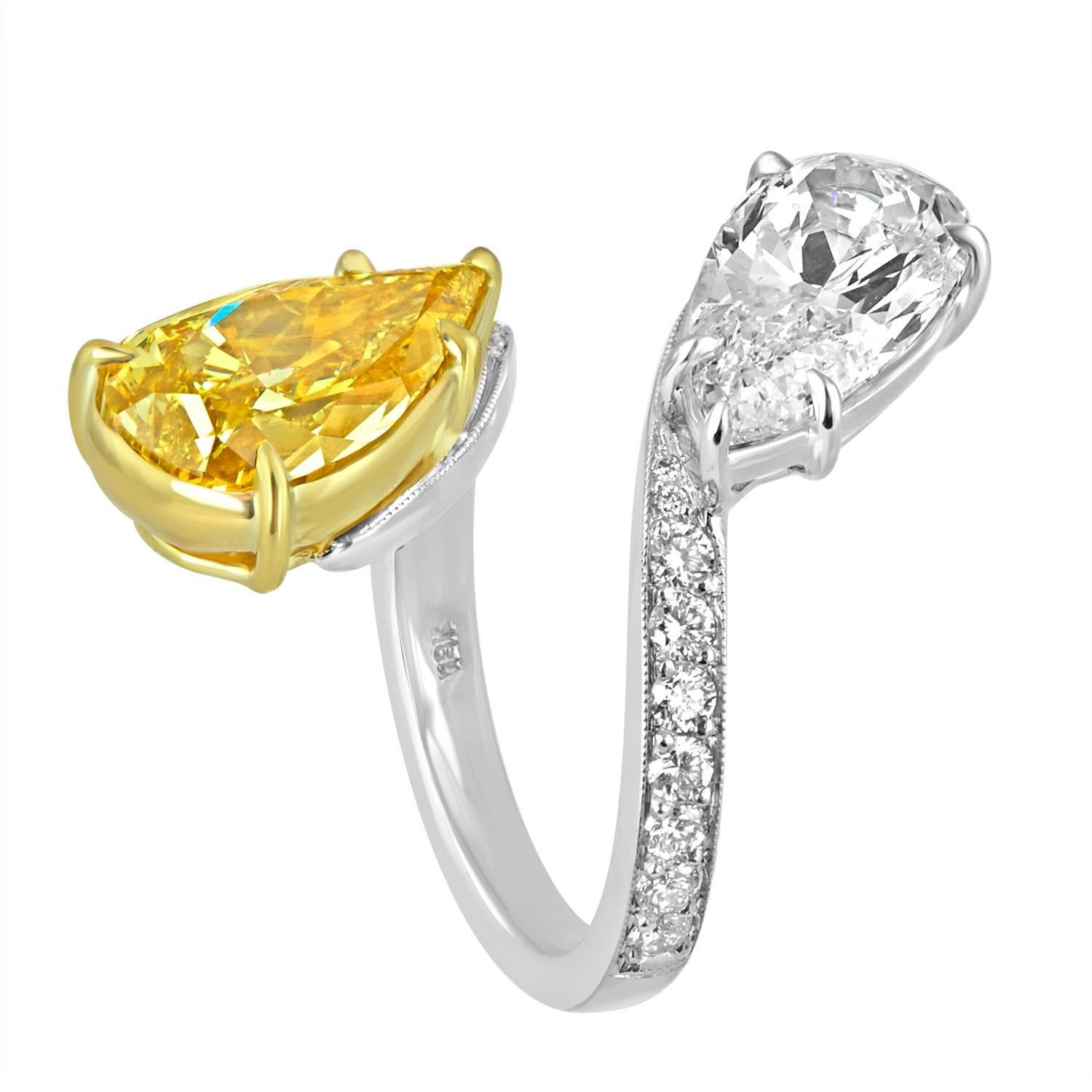 A unique bypass ring created to impress. The 4.06 Carat Pear Shape is GIA certified as Fancy Brownish Yellow in Color and SI1 in Clarity and the White Diamond is a beautiful 3.02 Carat Pear Shape. Both diamonds are mounted in 18K White Gold and 18K