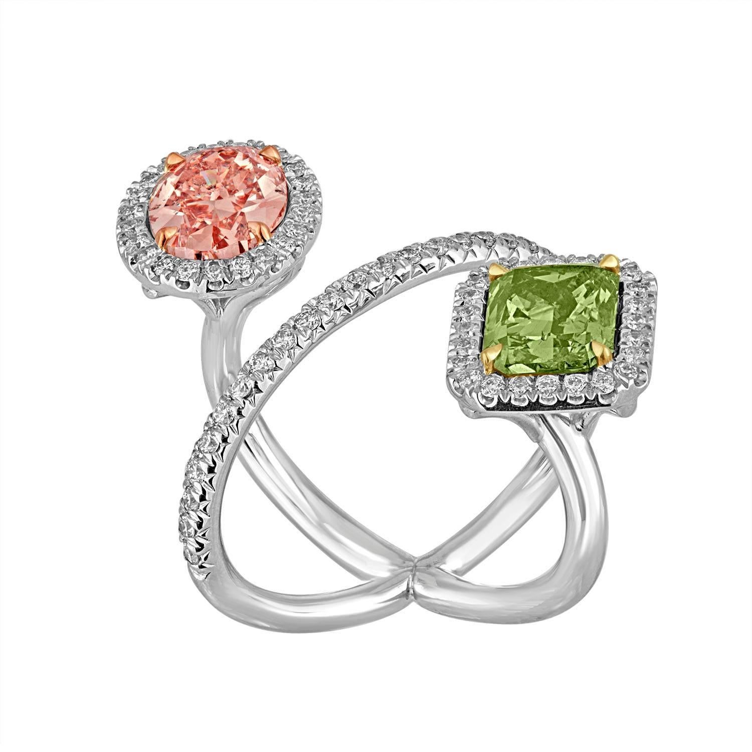 A 2.15 Carat Oval, GIA Fancy Brown Pink is set with a beautiful 2.40 Carat Cushion GIA “CHAMELEON”, Fancy Deep Grayish Yellowish Green Diamond. The stones are set in an Elegant 18k White Gold Ring.
The Two center Diamonds are set with white melee,