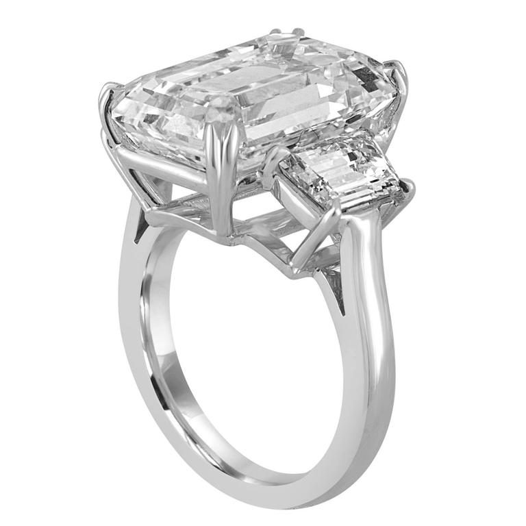 GIA certified Emerald Cut Diamond as J in Color and VS1 in Clarity, is set in Platinum Ring Mounting with Two Trapezoids, 2.04 Carat Total Weight which gives it the contemporary Chic look.