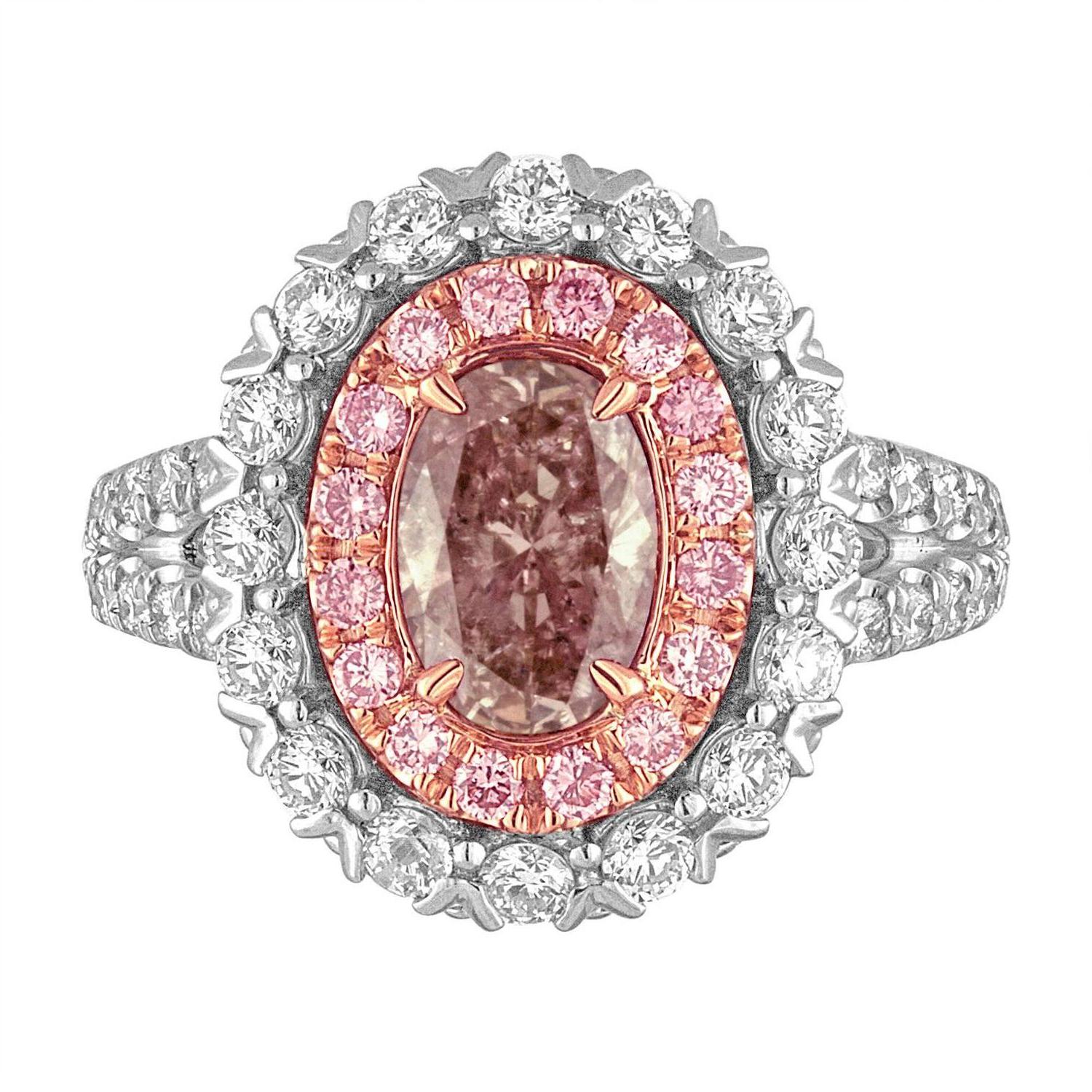 1.10 CT Oval GIA certified to be Fancy Brownish Pink Diamond is set in Platinum  and Rose Gold Mounting.
The 1.10 CT Oval is set in Hand Crafted Mounting and surrounded by one row 16 Brilliants of Pink Diamonds weighing 0.23 Carat Total Weight.