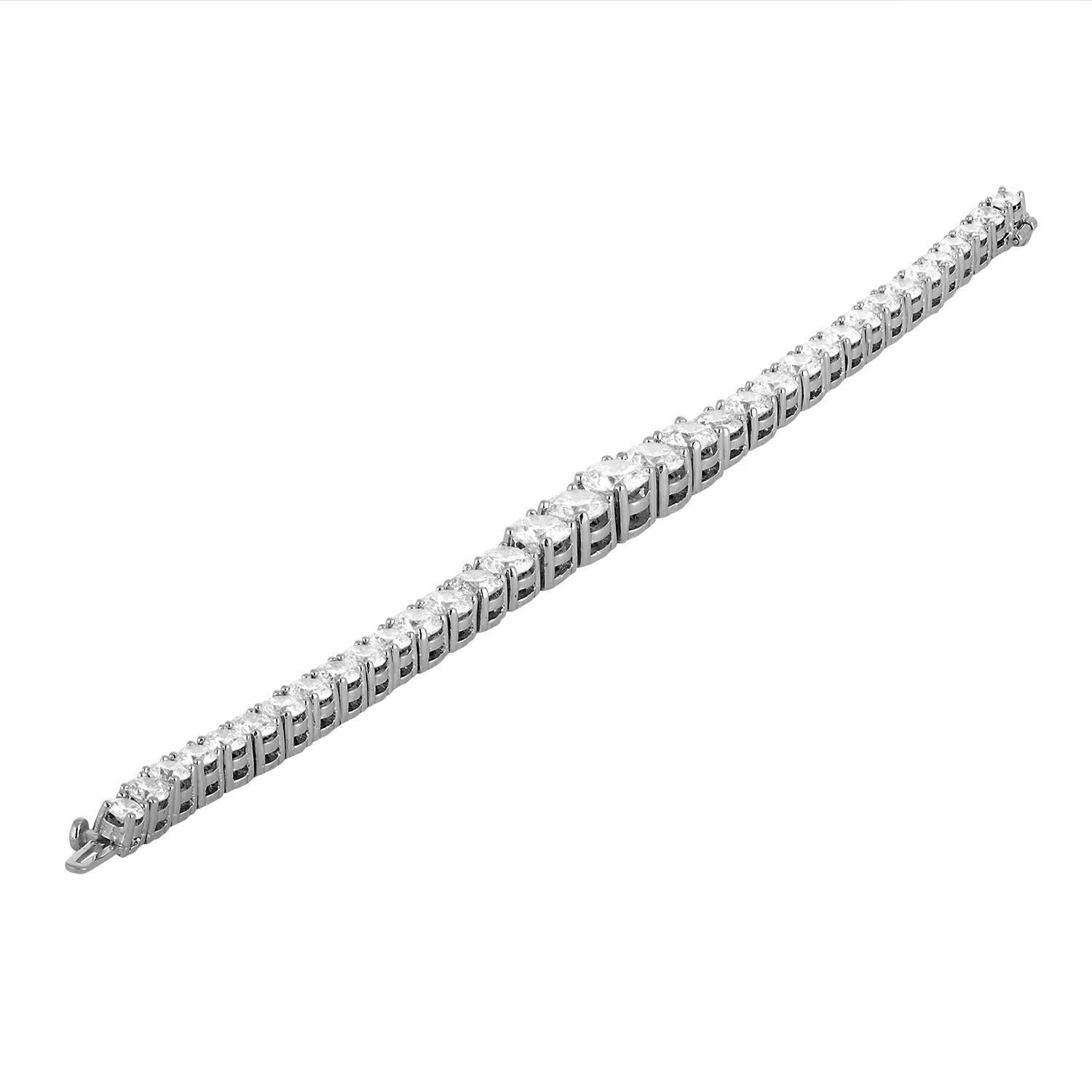 A Very unique and different looking Tennis Bracelet. It is not an average Tennis Bracelet. This Bracelet has 35 Brilliant White Diamonds, estimated to be H in color and VS - SI in clarity. The center stone is 1.32 Carat and the Diamond sizes are