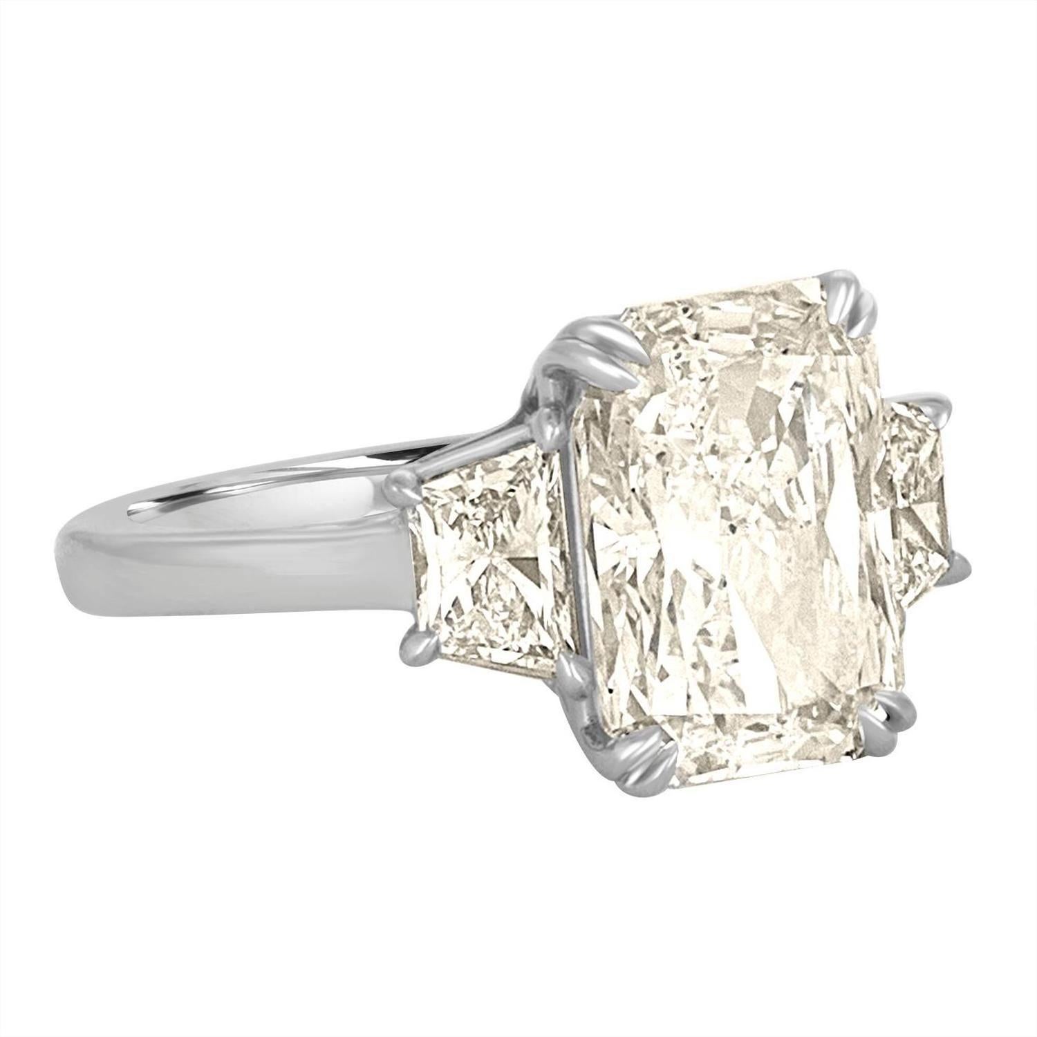 A 5.12 Carat Radiant set in a Classic Three Stone ring with Matching Trapezoids in a Platinum Ring Mounting. 
The Center Diamond is Certified by GIA as J in Color and SI1 in Clarity.
the GIA Certificate number is 1172550549.
 