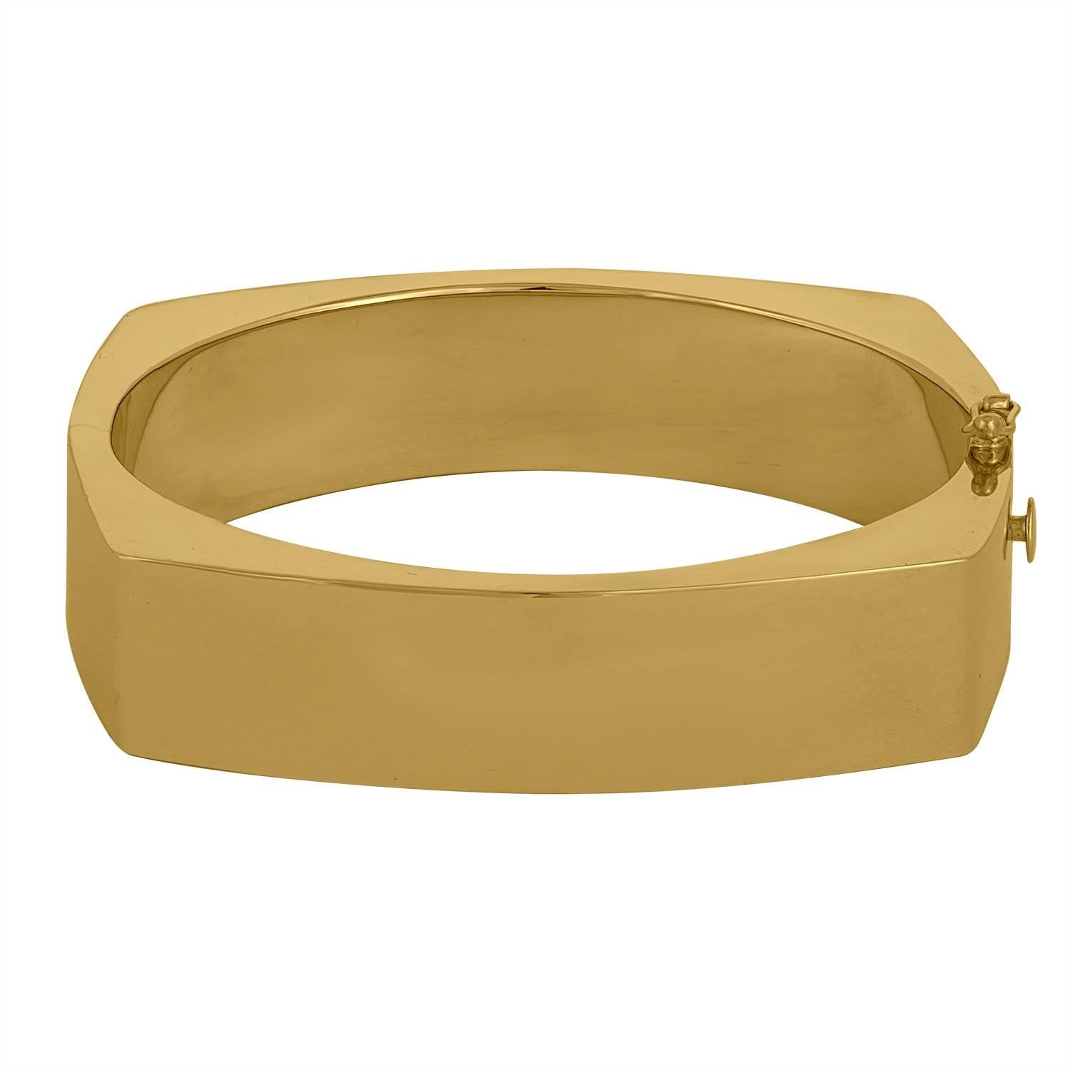 30.73 Grams of 14K Yellow Gold Square looking Bangle. 
This Rectangular Bangle has the 70'-80' Look. 
This Approximate 1.5 Centimeter wide Bangle  has an opening from the side with Double Lock to it for Safety.

