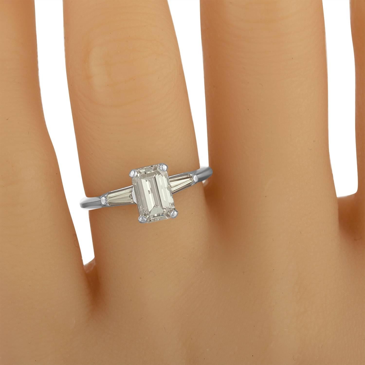 Long Looking Emerald Cut is set in 14K White Gold Ring Mounting with Two Tapered Baguettes. The Side Stones are Estimated to be 0.35 carat total Weight. the Center Weigh 1.02 Carat. It is your Classic Engagement Ring.
The Emerald Cut Diamond is