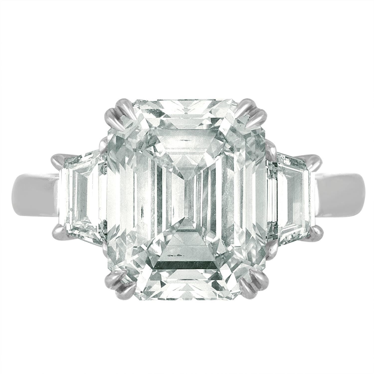 6.02 Carat Emerald cut Diamonds Certified by the GIA as I in Color and VS2 in Clarity.
The Center Stone is set with Two Step Cut Trapezoids to match the Emerald Cut Diamond. The Trapezoids are 0.58 Carats Total Weight.
Three Matching Diamonds are
