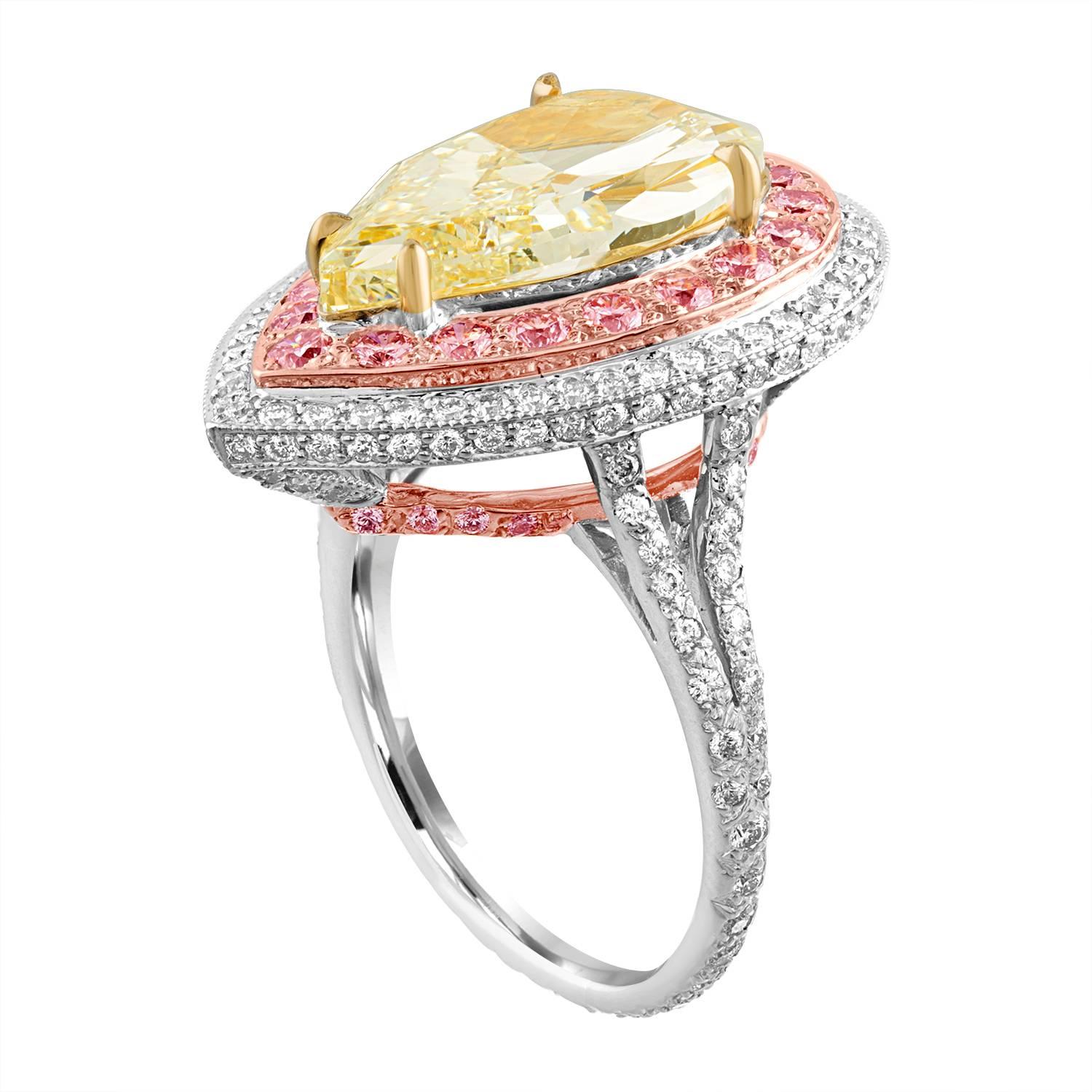 6.92 Carat Pear Shape Diamond, GIA Certified Light Yellow, is set in a Three Colors Ring Mounting.
The Pear Shape is set in Yellow Gold Box, Surrounded by a row of 19 Pink Diamonds set in Rose Gold, Surrounded by a row of 46 White Round Brilliants