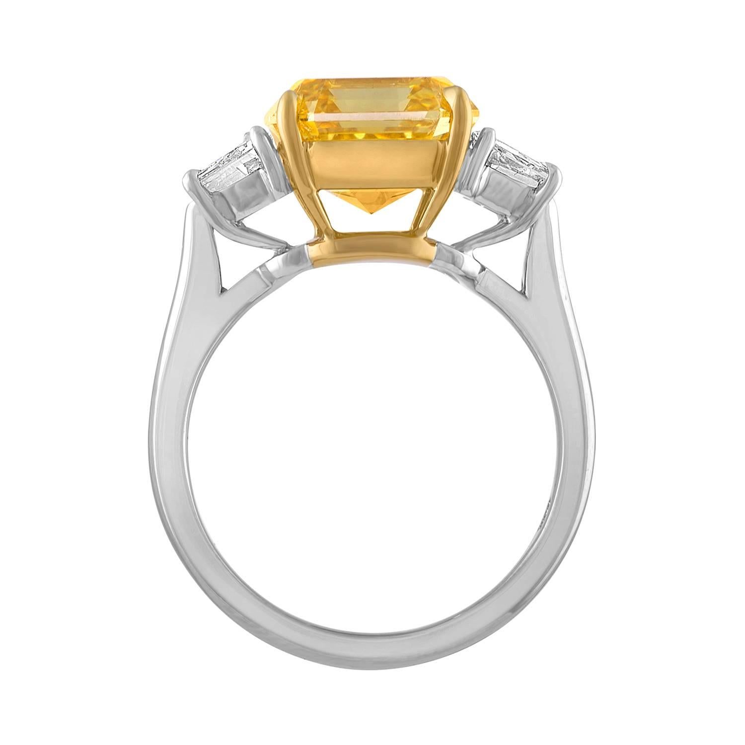 A Beautiful 5.04 Asscher Cut Diamond is set in Two Tone Mounting to Emphasize the Shades of the Two Different Colors in this Ring.
The 5.04, which is set in the Center, is a GIA Certified Diamond, to be Fancy Brownish Yellow Diamond and VS1 in