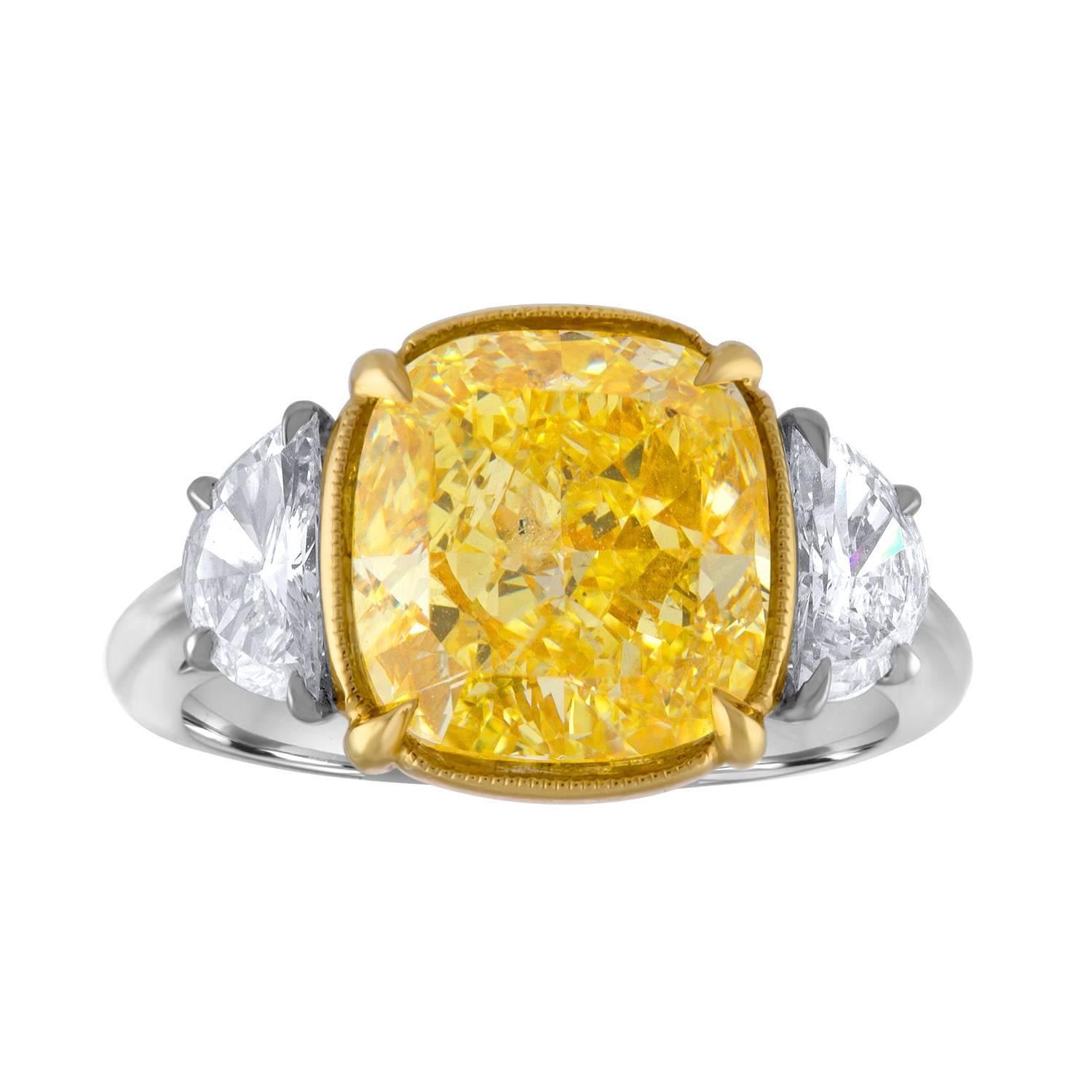 Beautiful Platinum and 18K Yellow Gold Hand Crafted Mounting. The Center is 5.04 Carat Cushion Cut Diamond which is GIA Certified to be Fancy Intense Yellow. 
GIA Certificate Number is - 17217092.

The Center Diamond is set in 18K Yellow Gold .
Two